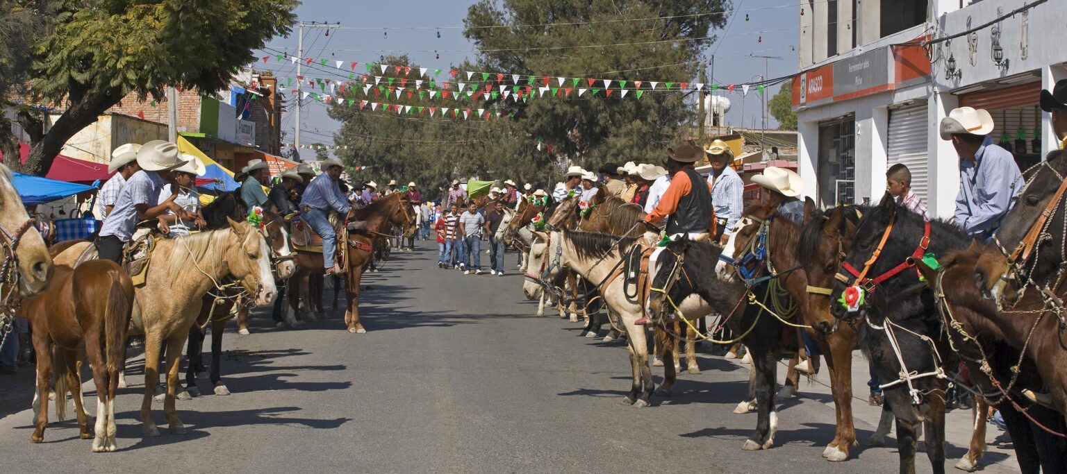 CABALLEROS or Mexican cowboys ride into town to celebrate the festival of the VIRGIN OF GUADALUPE - LOS RODRIGUEZ, GUANAJUATO, MEXICO