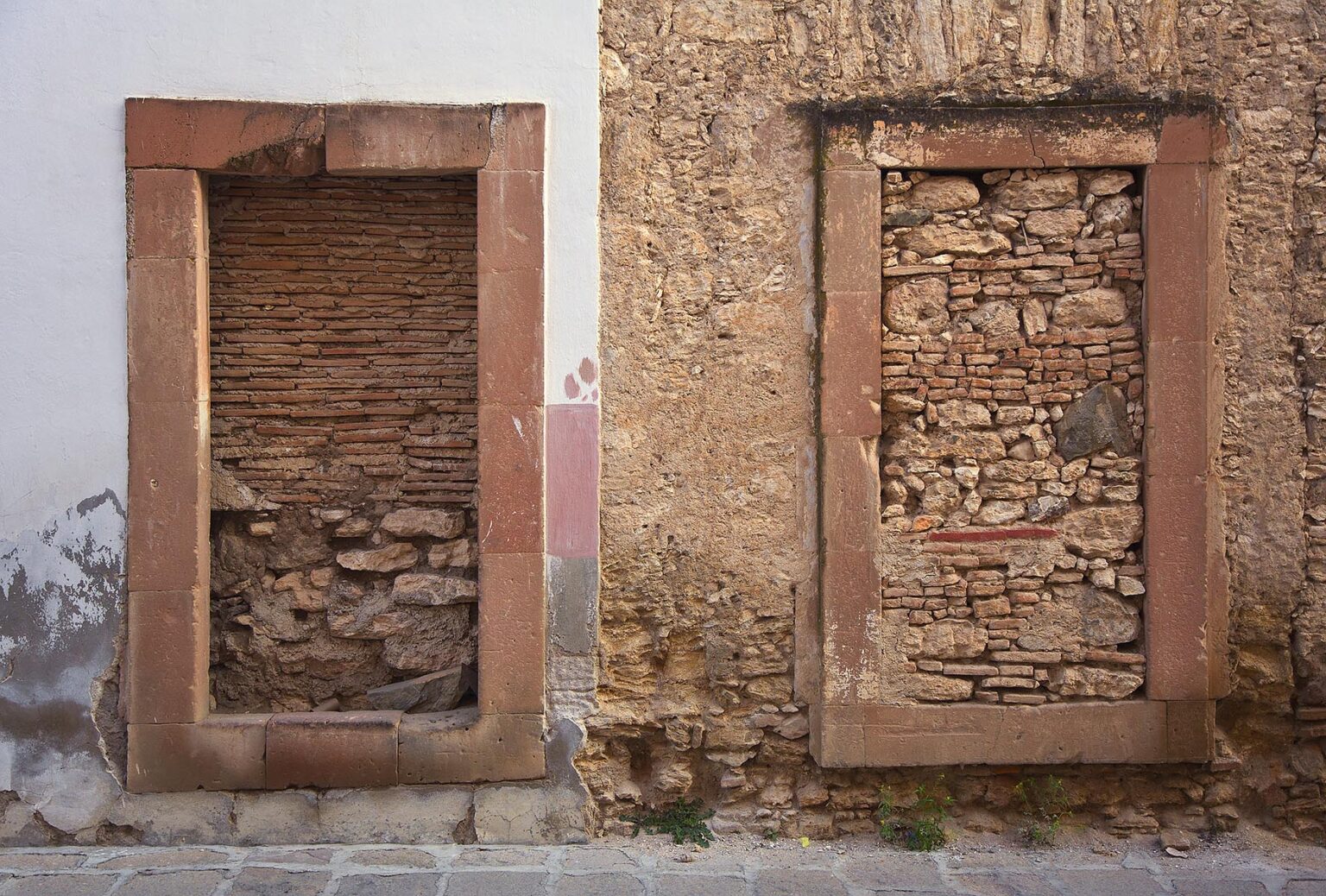 Stones block DOORWAYS in the ghost town of MINERAL DE POZOS which is now a small artist colony and tourist destination - GUANAJUATO, MEXICO