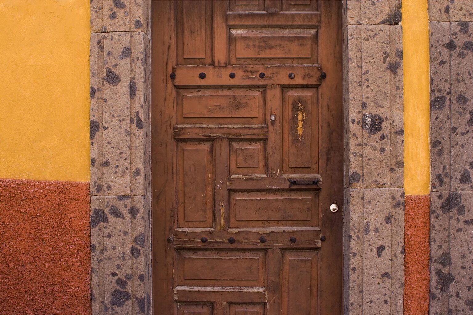 Stonework, wooden doors and bright orange and red paint are part of the architectural style of SAN MIGUEL DE ALLENDE - MEXICO