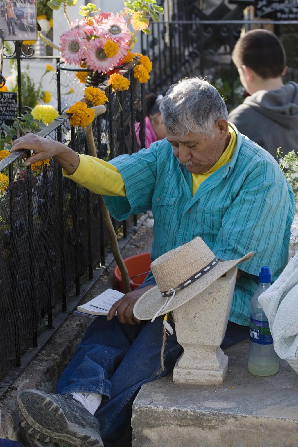 A man reads to a dead loved one at the local cemetery during the DEAD OF THE DEAD - SAN MIGUEL DE ALLENDE, MEXICO