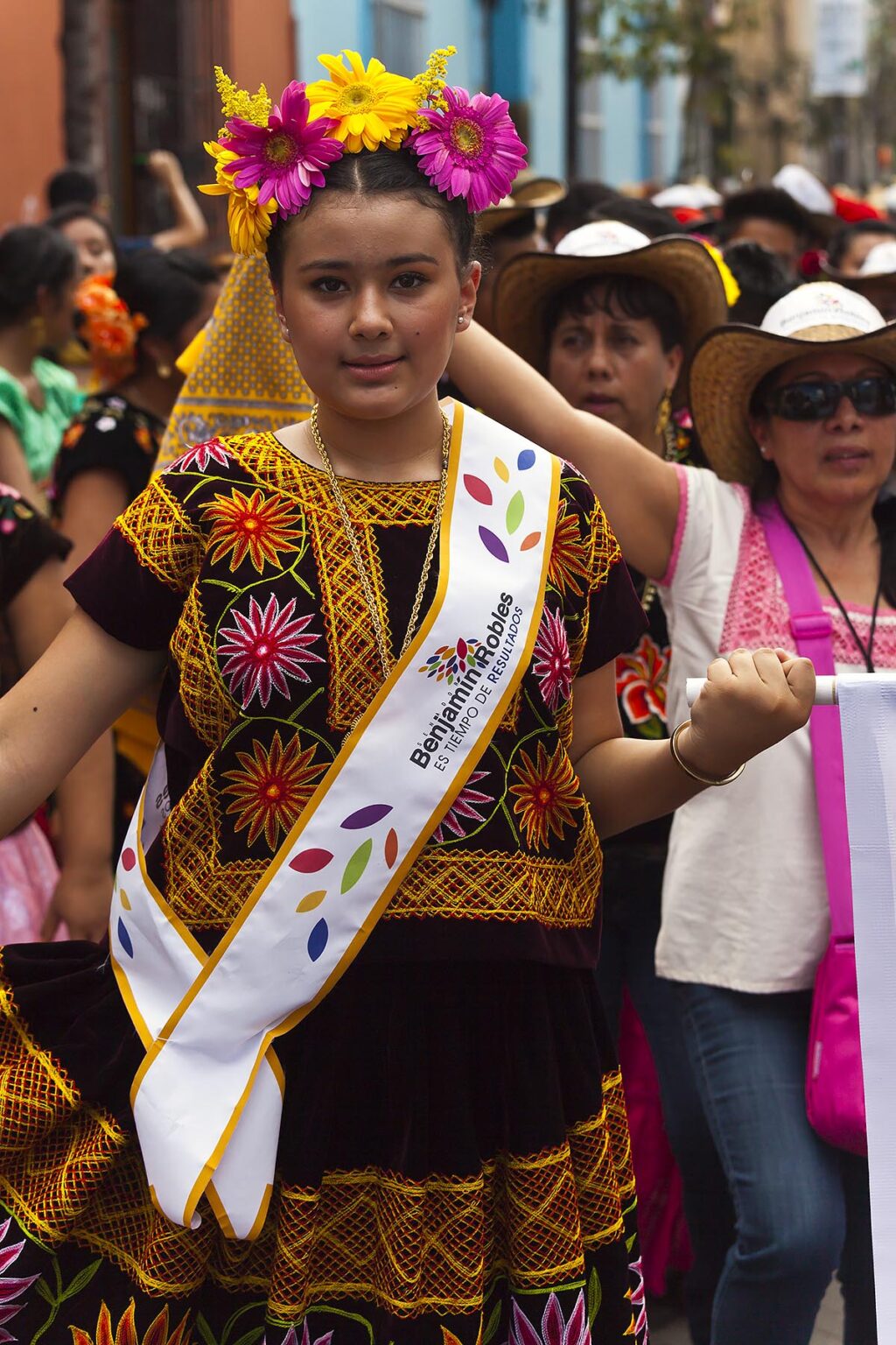 A traditionally dressed Mexican woman in a parade during the July GUELAGUETZA FESTIVAL - OAXACA, MEXICO