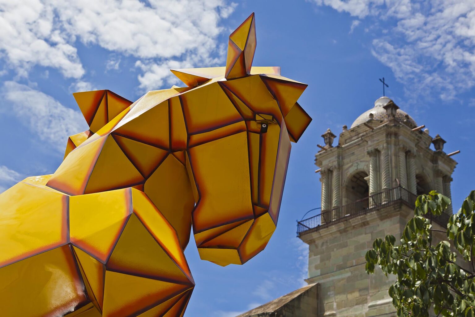A YELLOW HORSE SCULPTURE on display in front of the Oaxacan Cathedral - OAXACA, MEXICO
