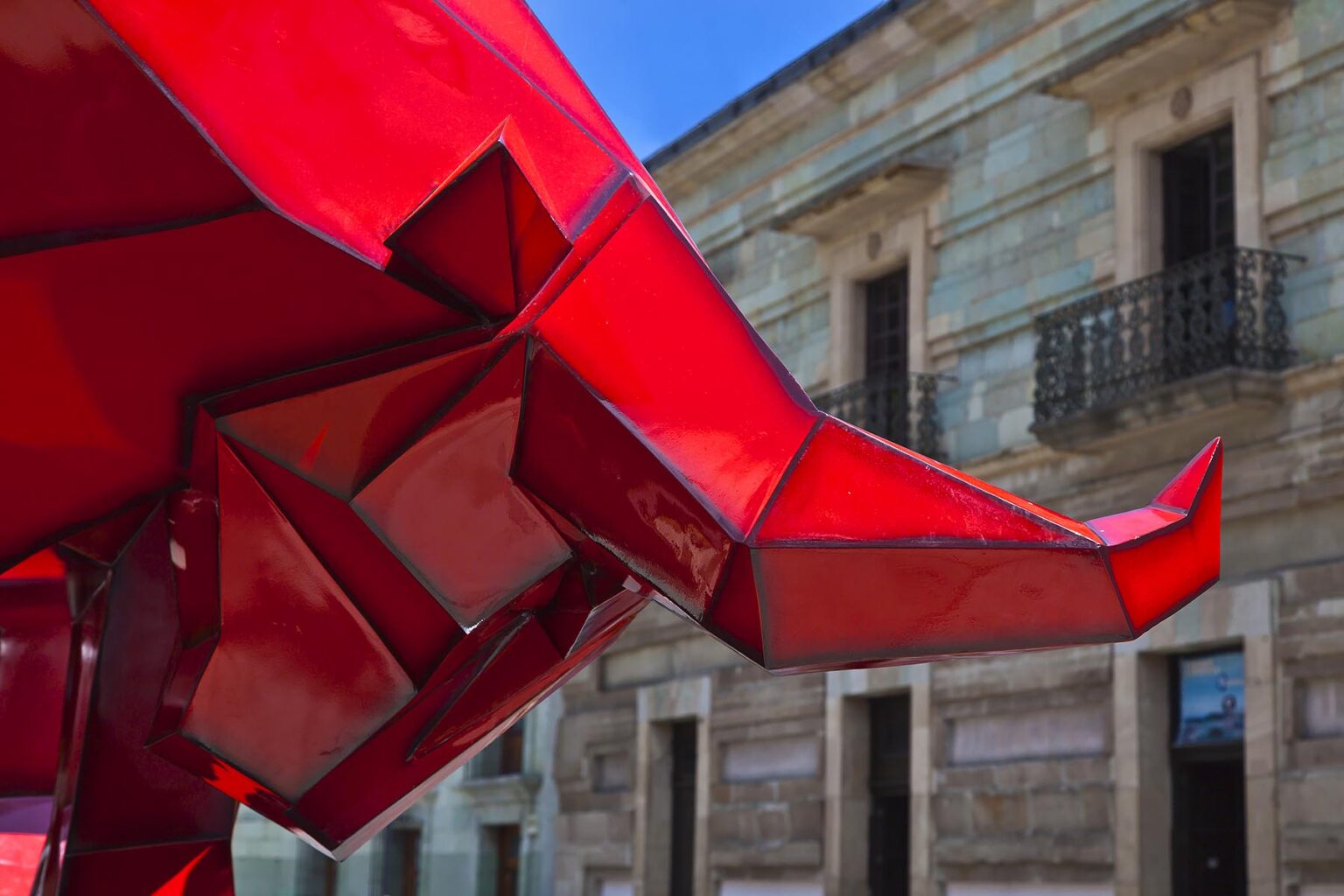 A RED BULL SCULPTURE by FERNANDO ANDRIACCI on display in front of the Oaxacan Catherdral - OAXACA, MEXICO