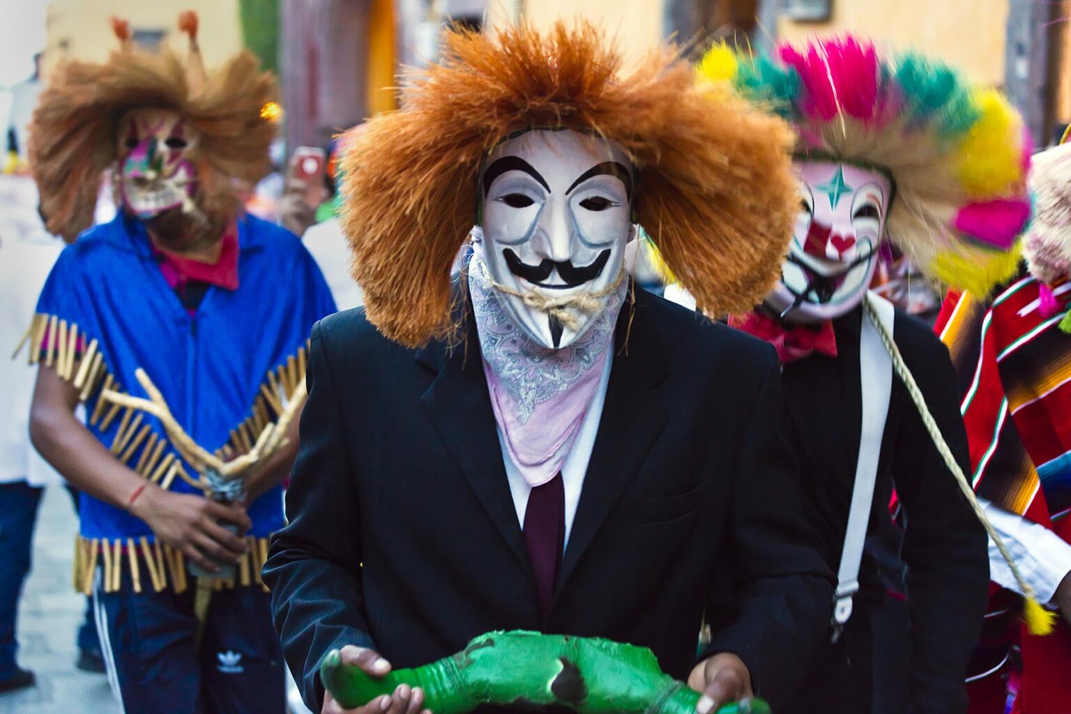 Mexicans dressed in Guy Fox costumes during a parade celebrating the anniversary of the city - SAN MIGUEL DE ALLENDE, MEXICO