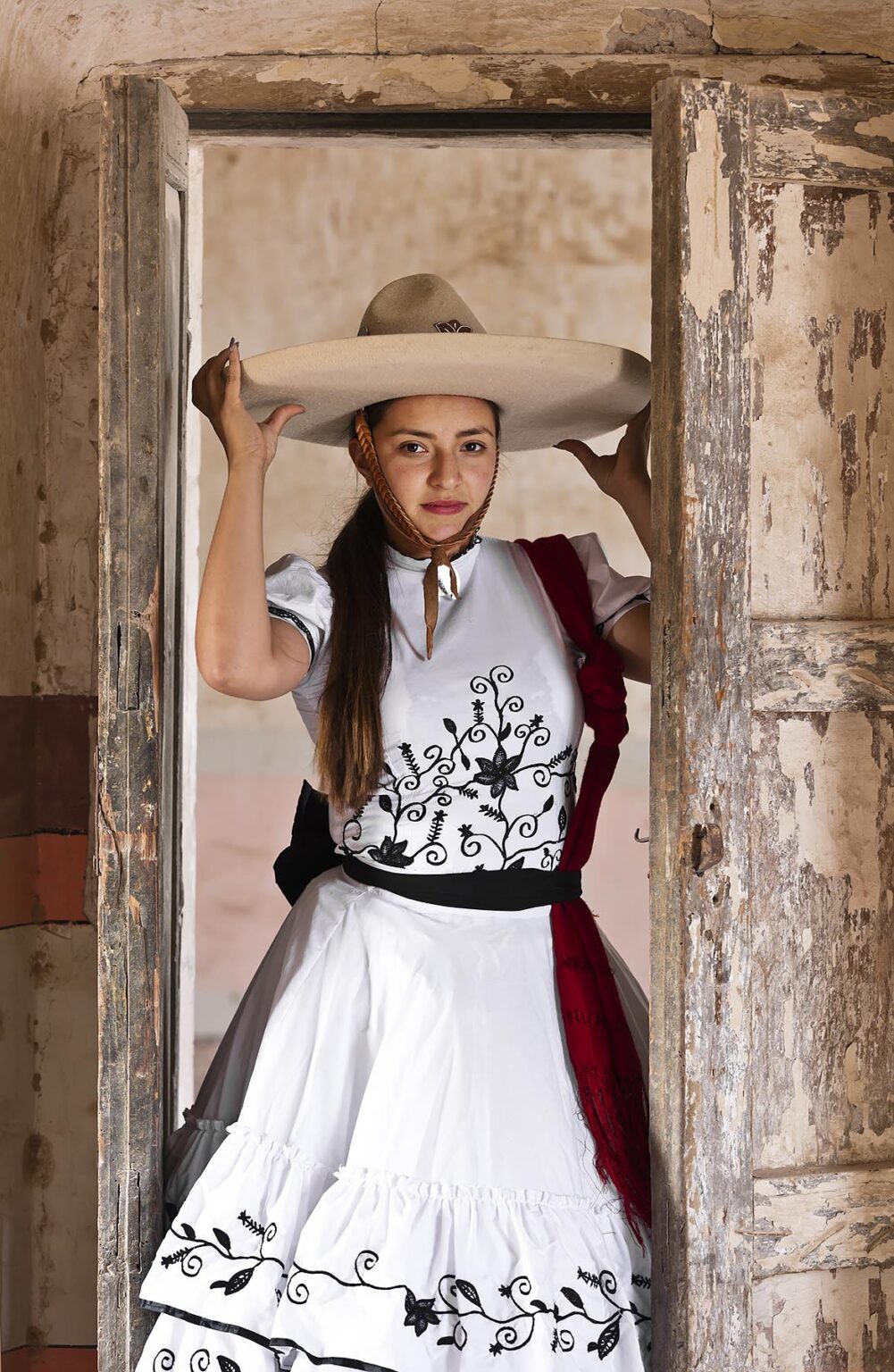 A Mexican girl wears a tradtional horse riding outfit at an old hacienda - SAN FELIPE, MEXICO