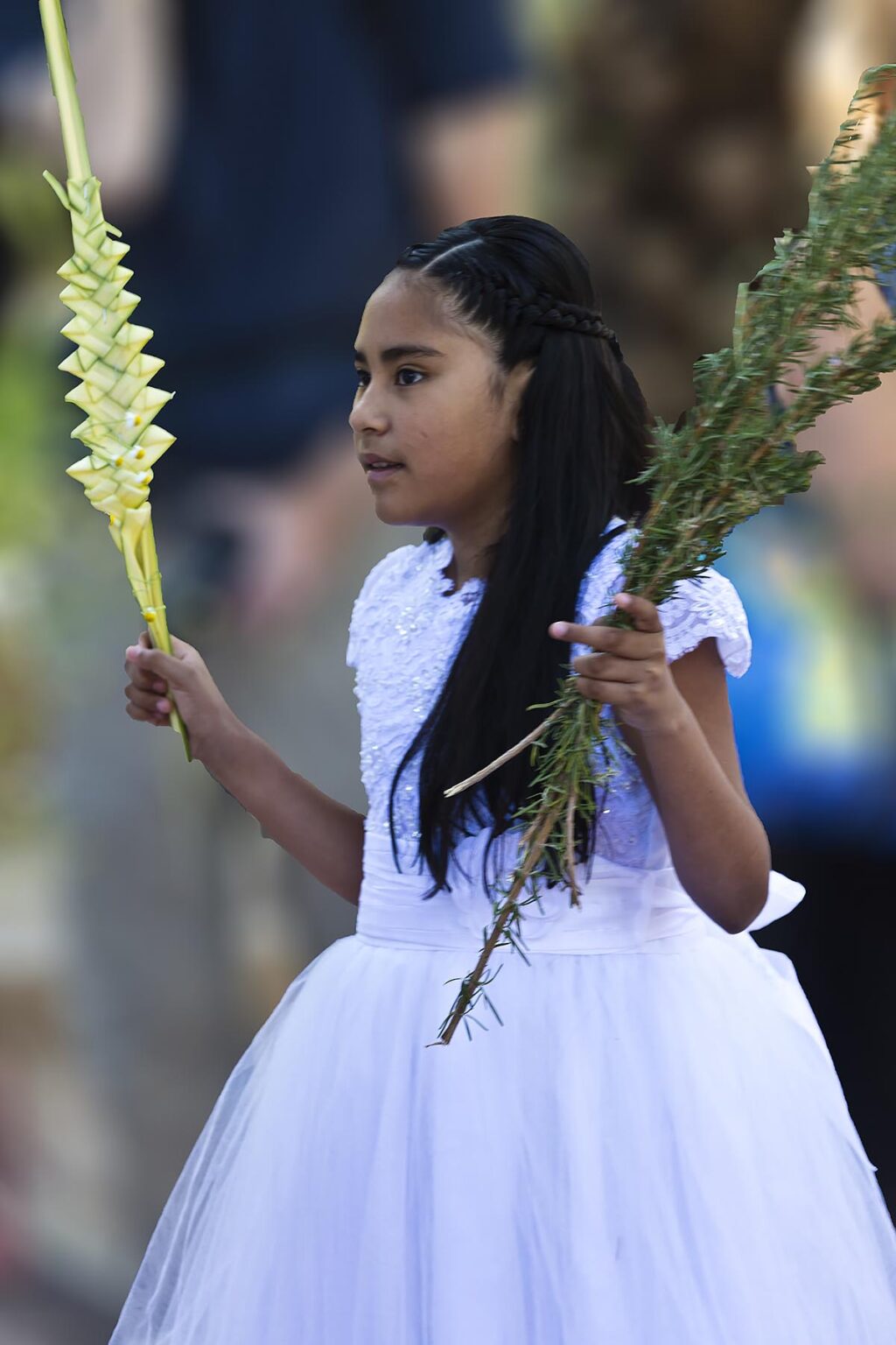 A young woman participates in the PALM SUNDAY procession from Parque Juarez to the Jardin - SAN MIGUEL DE ALLENDE, MEXICO