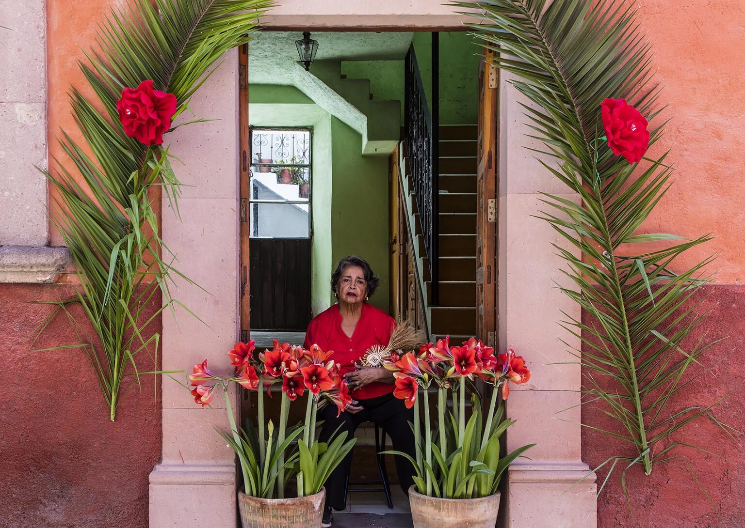 A Catholic woman has decorated her home along the route the PALM SUNDAY PROCESSION from Parque Juarez to the Jardin - SAN MIGUEL DE ALLENDE, MEXICO