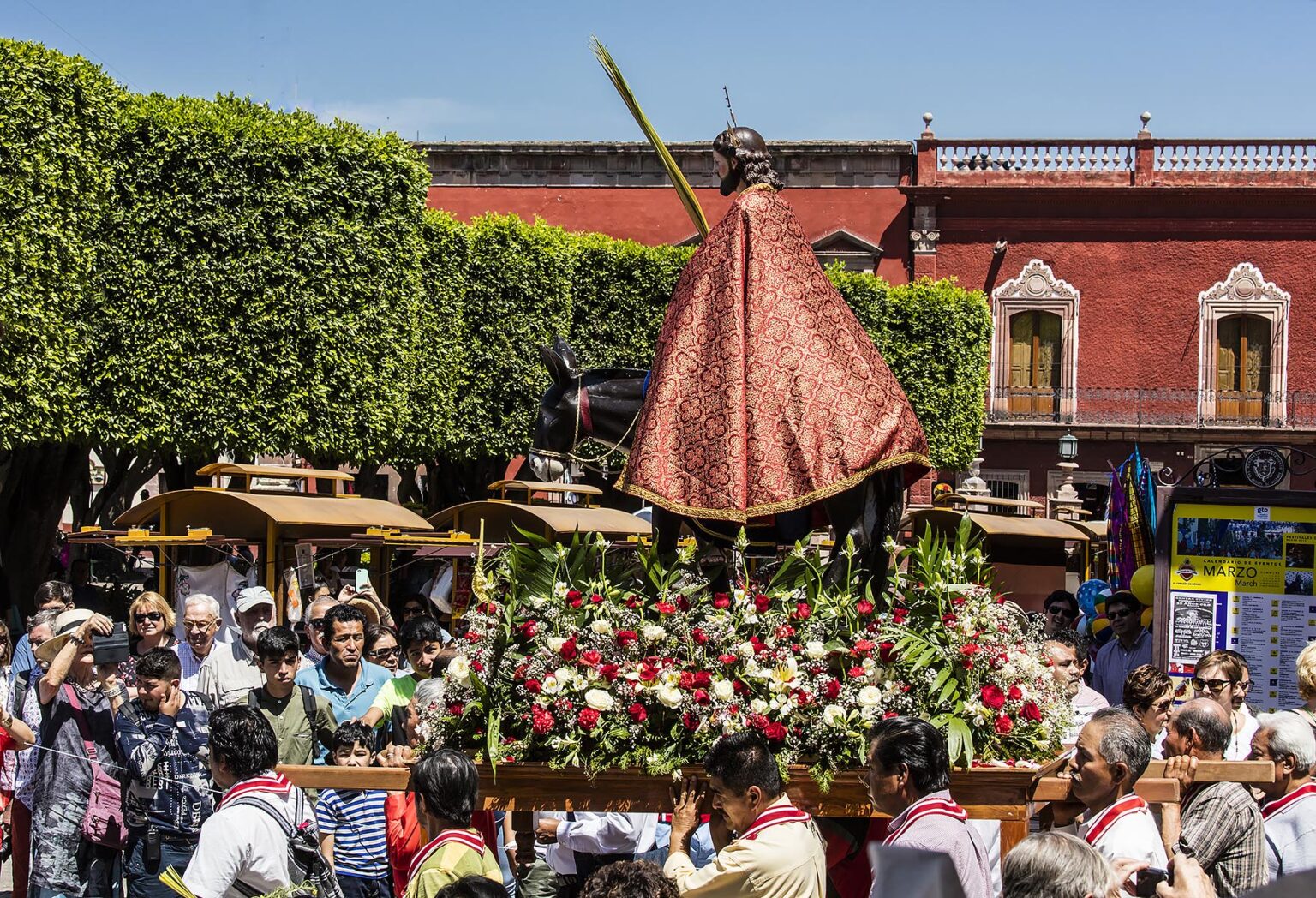 A statue of JESUS CHRIST is carried in the PALM SUNDAY PROCESSION from Parque Juarez to the Jardin - SAN MIGUEL DE ALLENDE, MEXICO