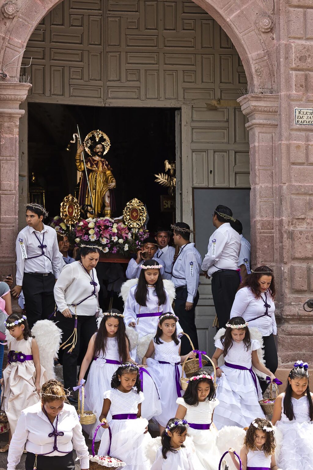 Young girls dressed as ANGELS descend the steps of the SAN RAFAEL chapel during the Good Friday Procession called Santo Encuentro - SAN MIGUEL DE ALLENDE, MEXICO