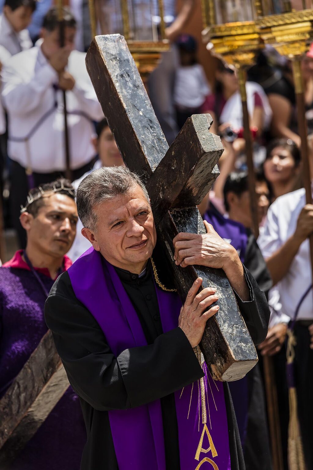 The head priest carry's a cross in a reinactment on the steps of the SAN RAFAEL chapel start the Good Friday Procession Santo Encuentro - SAN MIGUEL DE ALLENDE, MEXICO