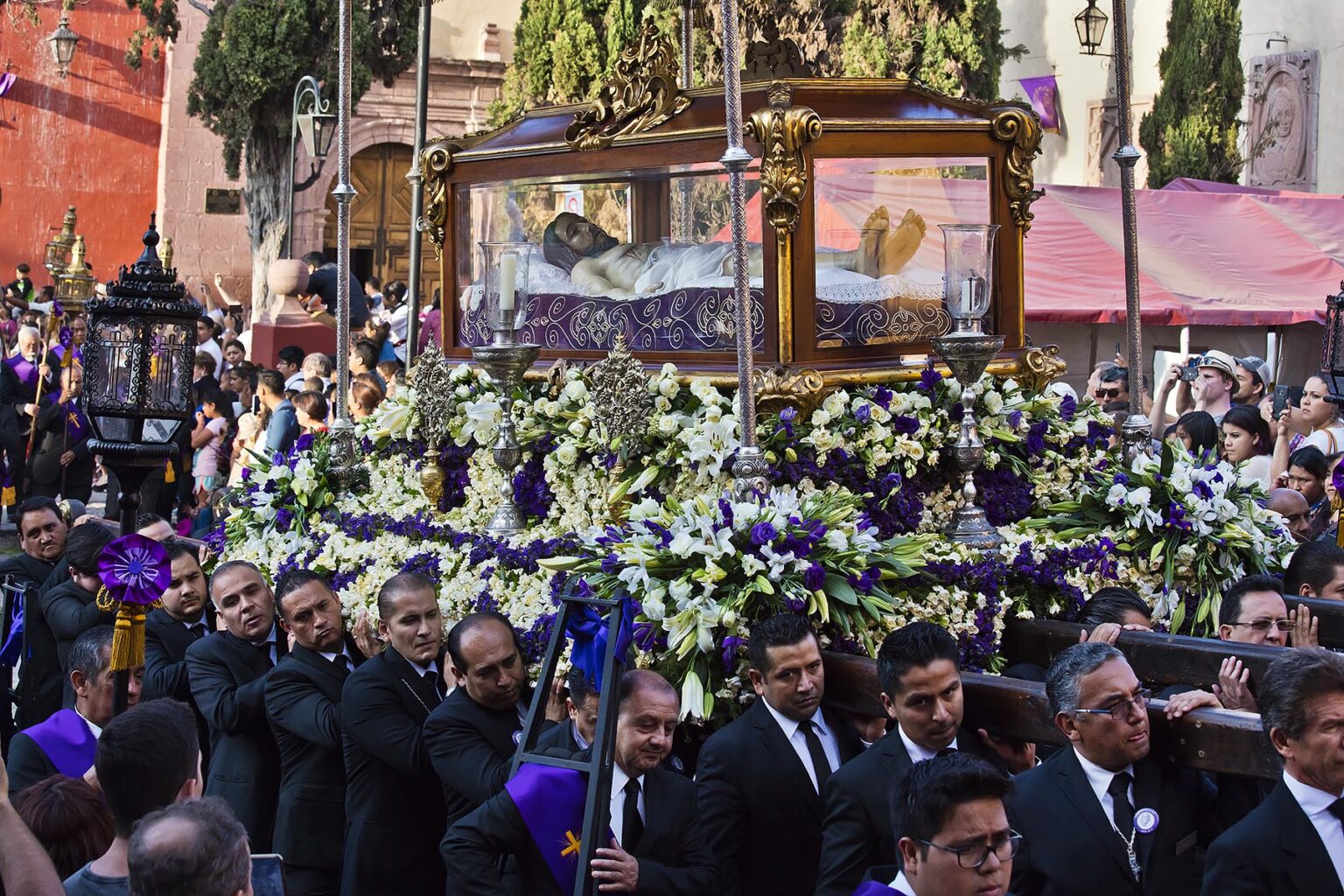 Mexican men carry a statue of JESUS IN A COFFIN in the Good Friday Procession, known as the Santo Entierro, from the ORATORIO CHURCH - SAN MIGUEL DE ALLENDE, MEXICO