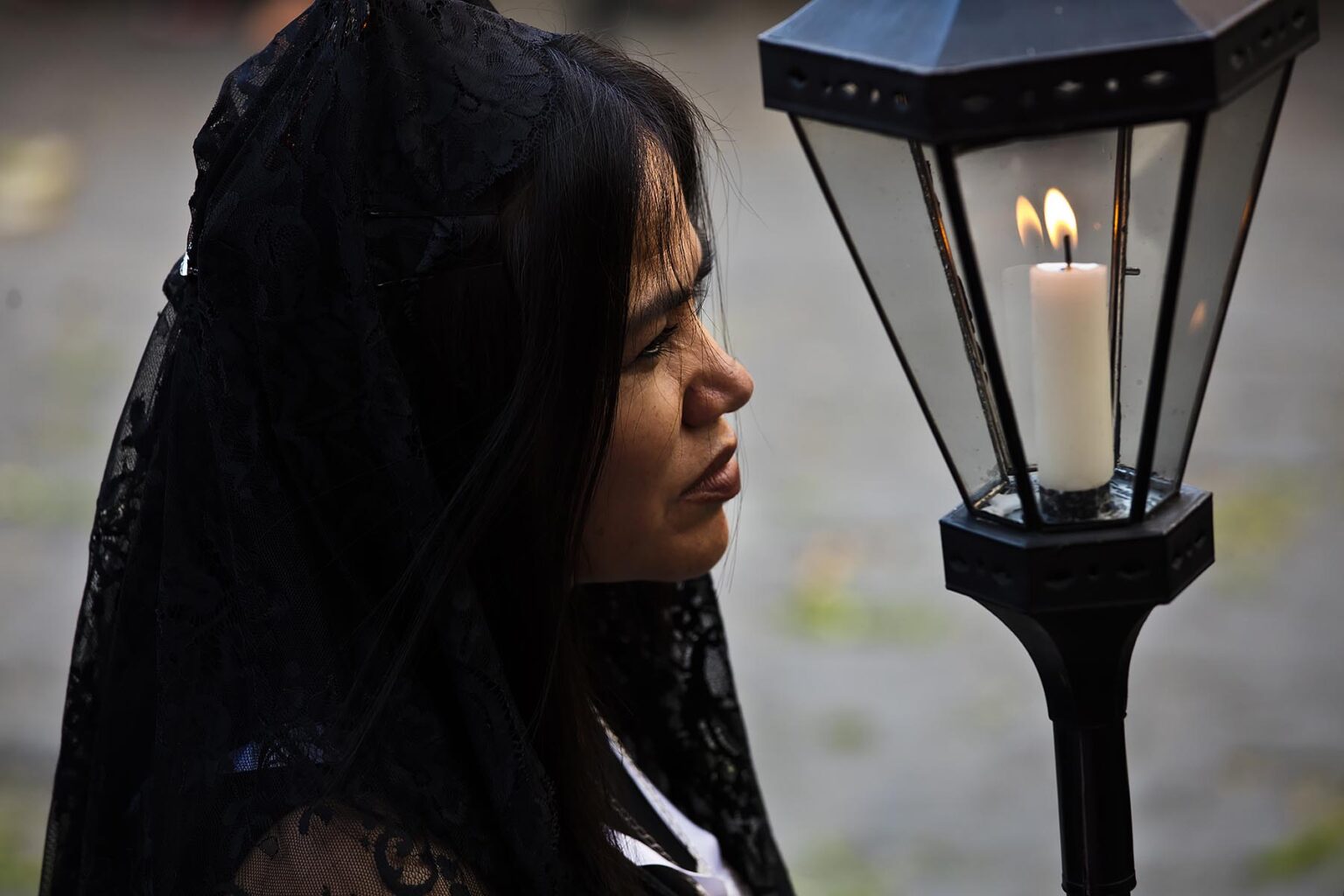 A Mexican woman dressed in traditional mantillas carries a candle lantern in the Good Friday Procession, known as the Santo Entierro, from the ORATORIO CHURCH - SAN MIGUEL DE ALLENDE, MEXICO