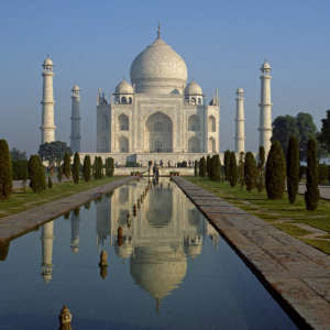 The TAJ MAHAL, built by emperor Shahjahan for his wife in 1653, REFLECTS in a POOL - AGRA, INDIA