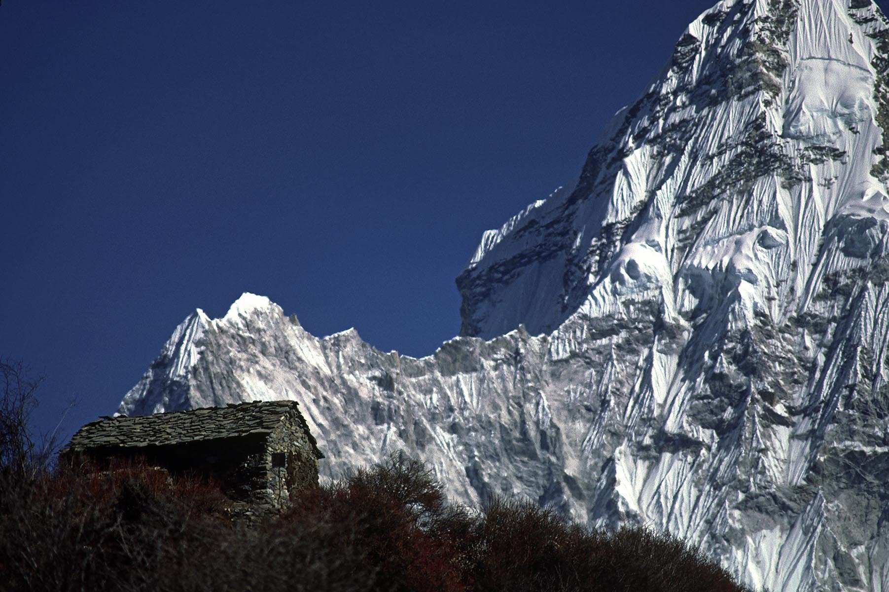A tea house sits in front of Ama Dablam (which means mother cradling a child) & reaches a height of 22,493 ft - KHUMBU DISTRICT, NEPAL