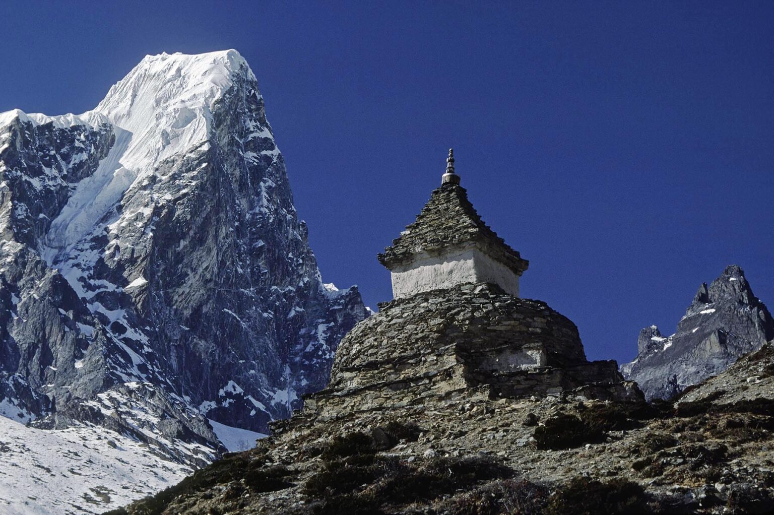 A Chorten & Himalayan peaks grace the skyline in the Everest Region - KHUMBU DISTRICT, NEPAL