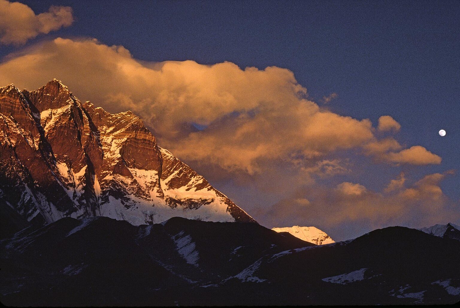 The sun sets on Lhotse which rises to 8501 Meters (28,005 feet) and is one of the worlds highest peaks - KHUMBU DISTRICT, NEPAL