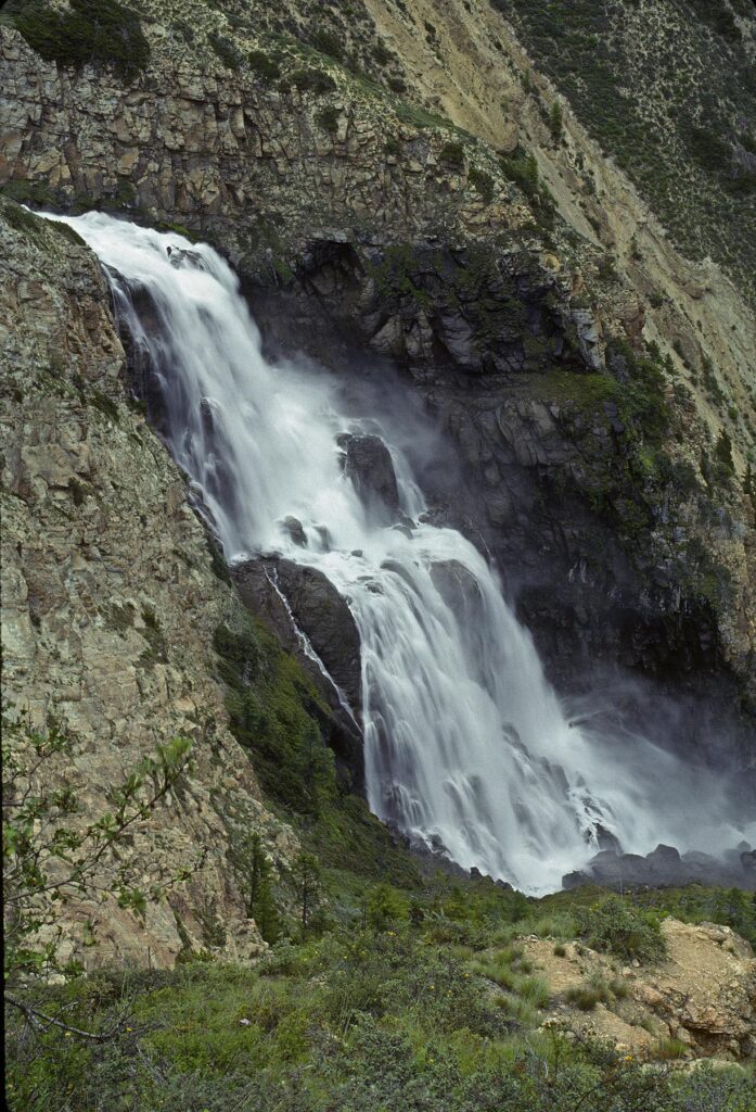 A WATERFALL on the SULI RIVER in a HIMALAYAN valley near RINGMO VILLIAGE drains Phoksundo lake - DOLPO DISTRICT, NEPAL