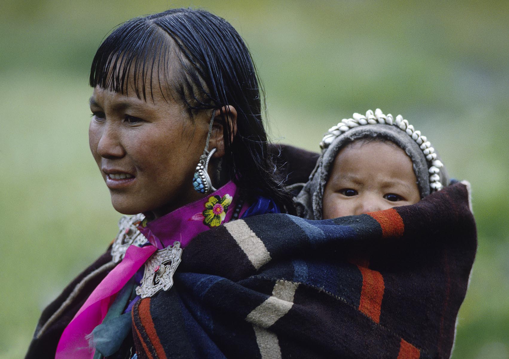 WOMAN and CHILD in DOLPO BLANKET and silver clasp at a Tibetan Buddhist FESTIVAL in DO TARAP VALLEY - DOLPO, NEPAL