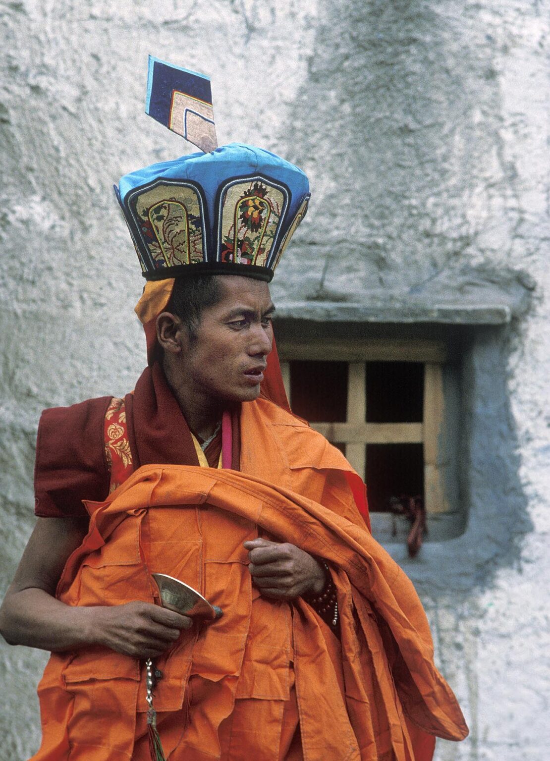 MONK of the pre-Buddhist BONPO religion stands in front of his MONASTERY near CHARKA VILLAGE - DOLPO, NEPAL