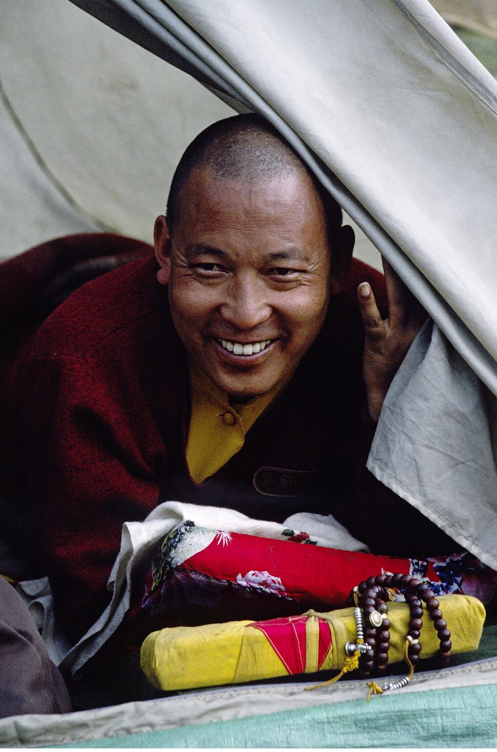 A high ranking Tibetan Buddhist MONK from MUSTANG in his TENT with his rosary and prayer book - DOLPO DISTRICT, NEPAL