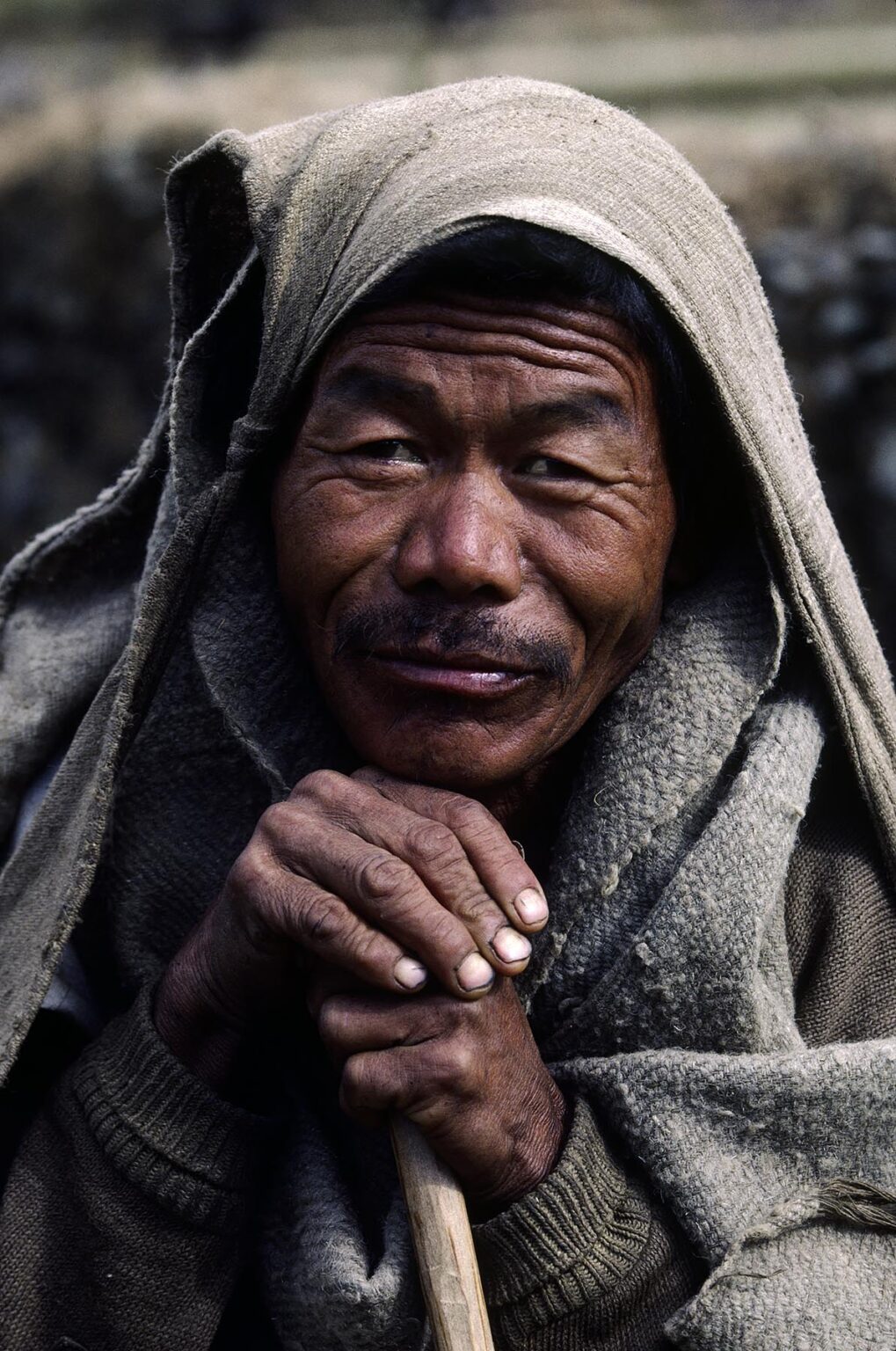 PORTRAIT of a GURUNG MAN with a blanket on his head - ANNAPURNA REGION, CENTRAL NEPAL