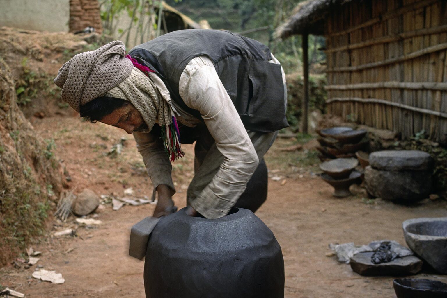 A POTTER makes a WATER POT from clay in the village of CHITTIGONG - BODHA HIMAL, NEPAL