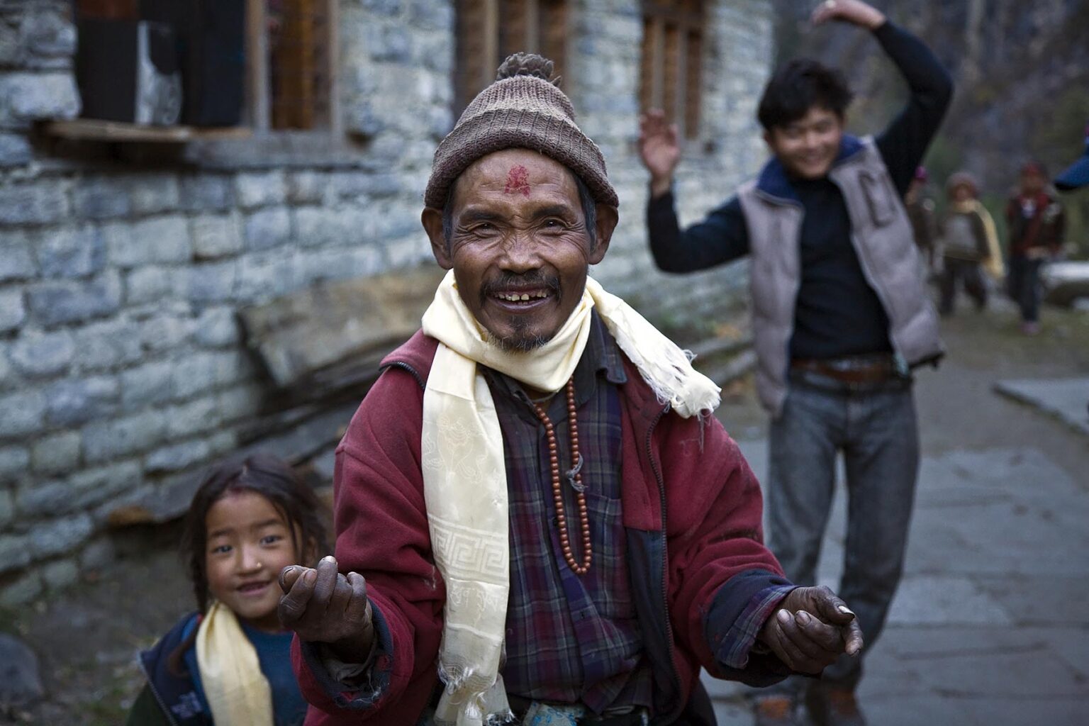 BUDDHIST villagers dance at a WEDDING CELEBRATION in the village of KOTO on the ANNAPURNA CIRCUIT - NEPAL HIMALAYA