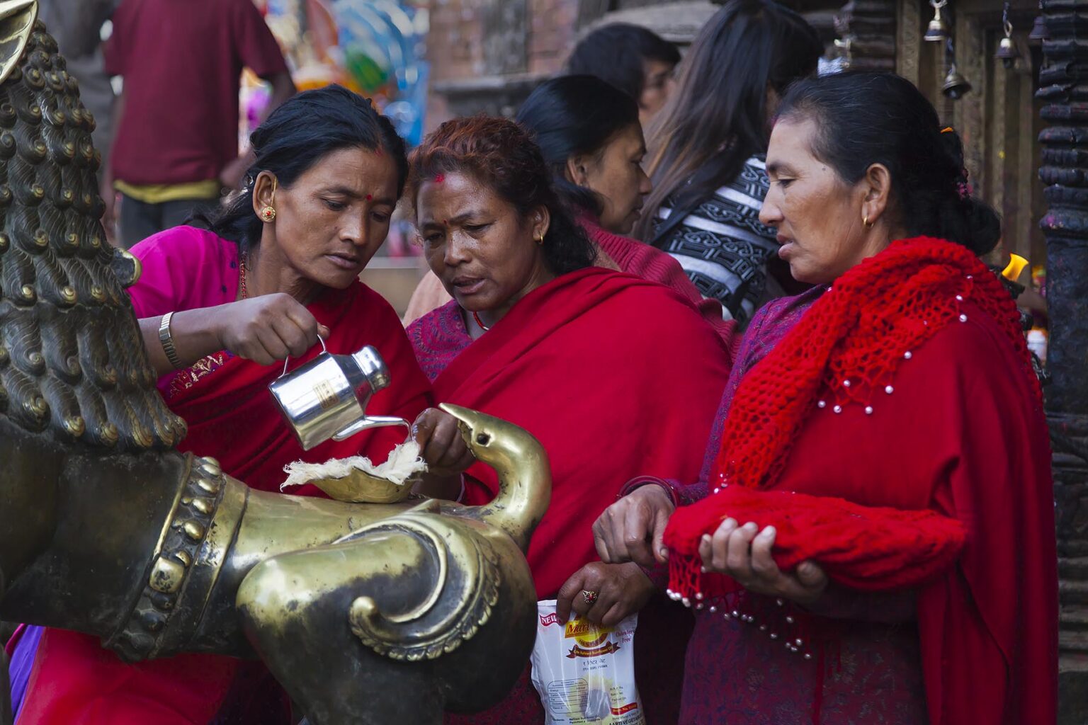 Villagers due puja at a temple in the traditional town of BHAKTAPUR which was severely damaged by the 2015 earthquake - NEPAL