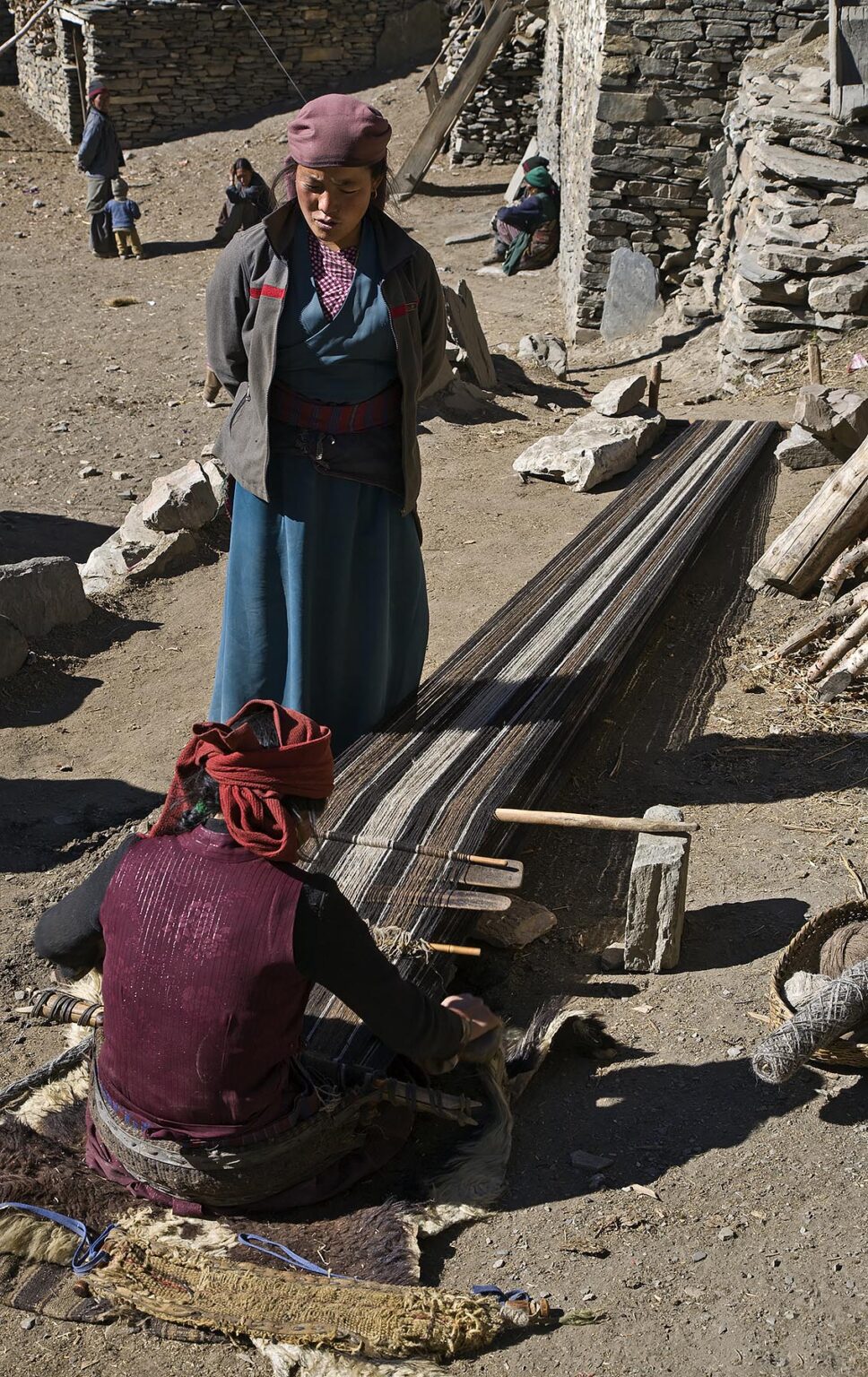 TIBETAN WOMAN weaves YAK WOOL on a BACKSTRAP LOOM in NAR village - NAR PHU TREK, ANNAPURNA CONSERVATION AREA, NEPAL