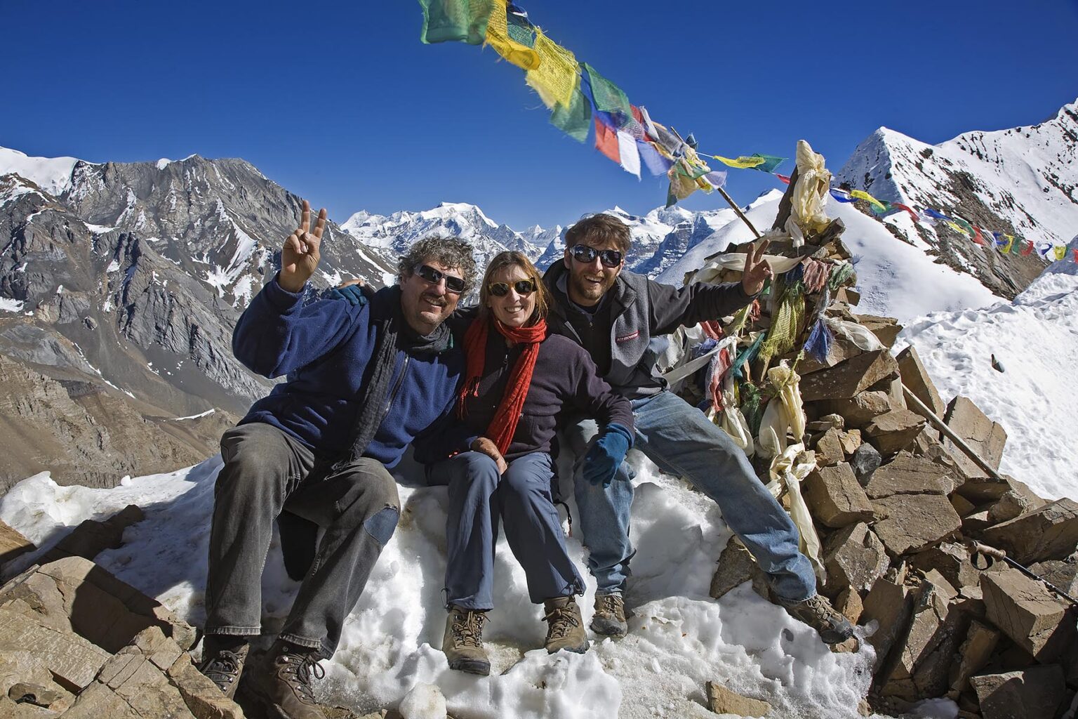 TREKKERS rest atop the KANG LA PASS at 5306 meters on the NAR PHU TREK - ANNAPURNA CONSERVATION AREA, NEPAL