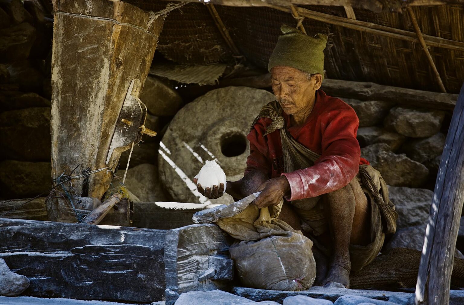 A NEPALI MAN grinds wheat into FLOUR using a stone water wheel - AROUND MANASLU TREK, NEPAL