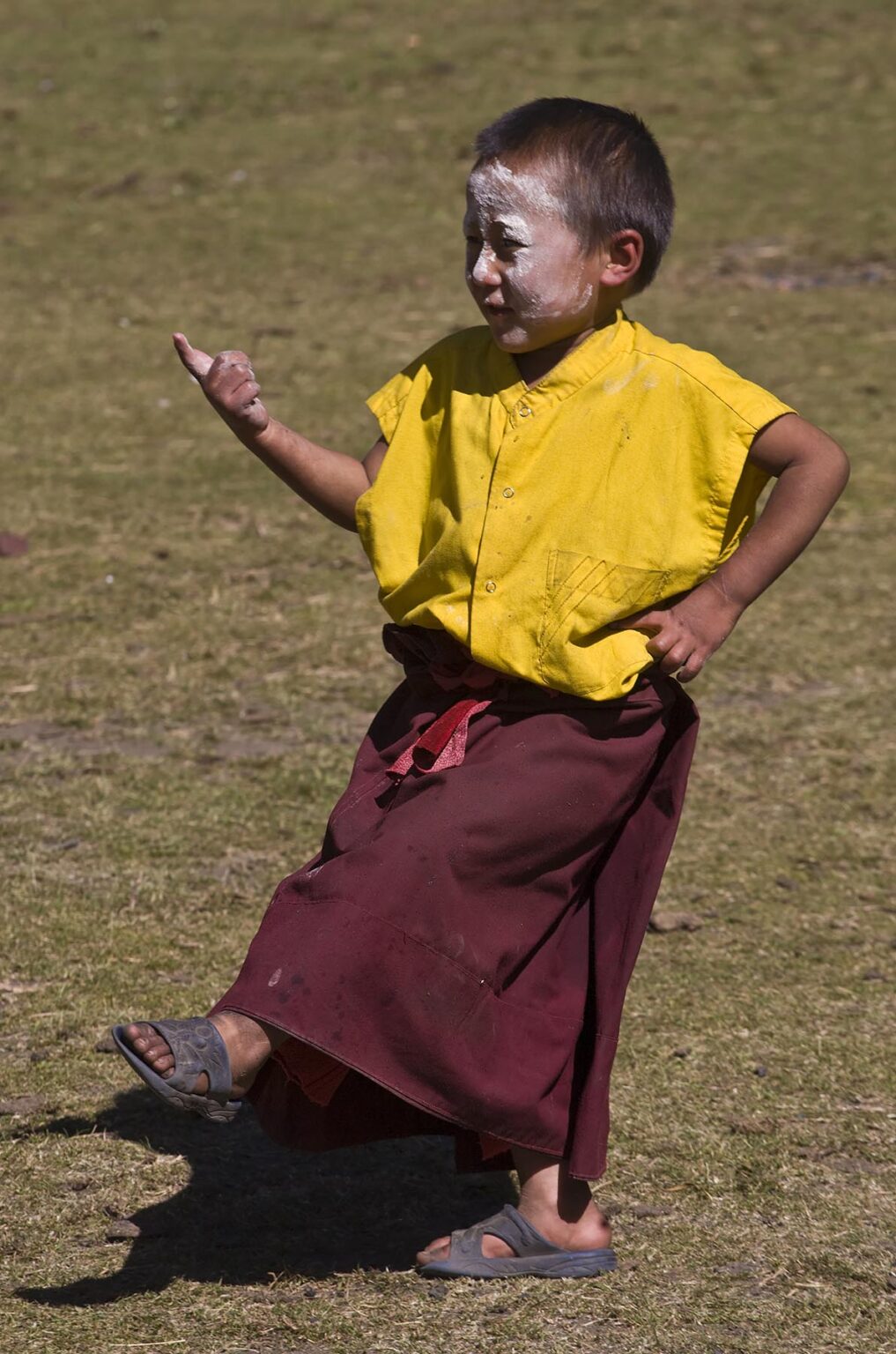 A young MONK practices tantric CHAM DANCING at a remote TIBETAN BUDDHIST MONASTERY - NEPAL HIMALAYA