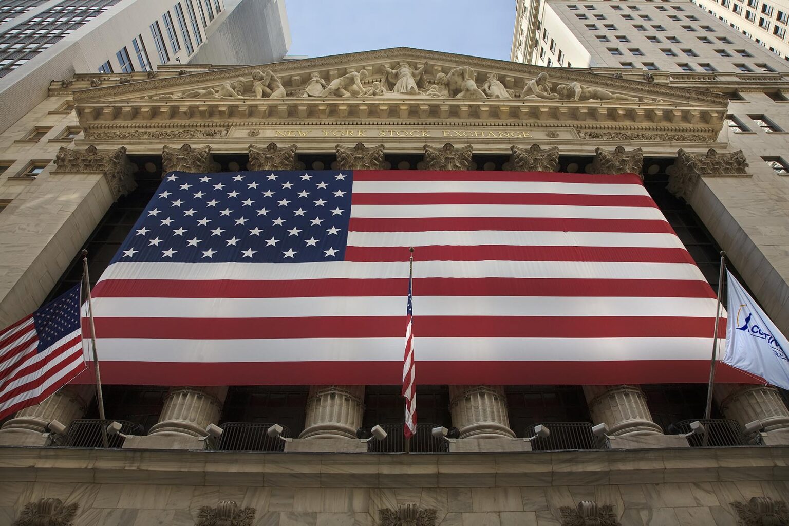 Large AMERICAN FLAG in front of the NYSE - NEW YORK CITY