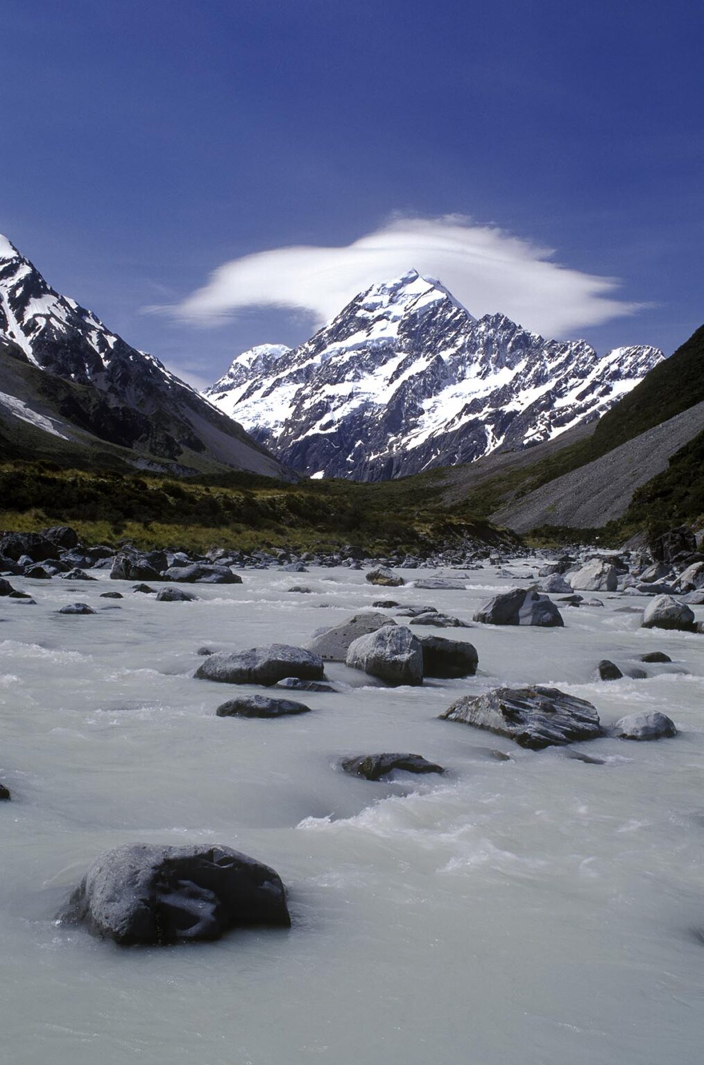 Glacial runoff flows down the HOOKER VALLEY below MT COOK, New Zealand's highest peak at 12,246 feet - MT COOK NP