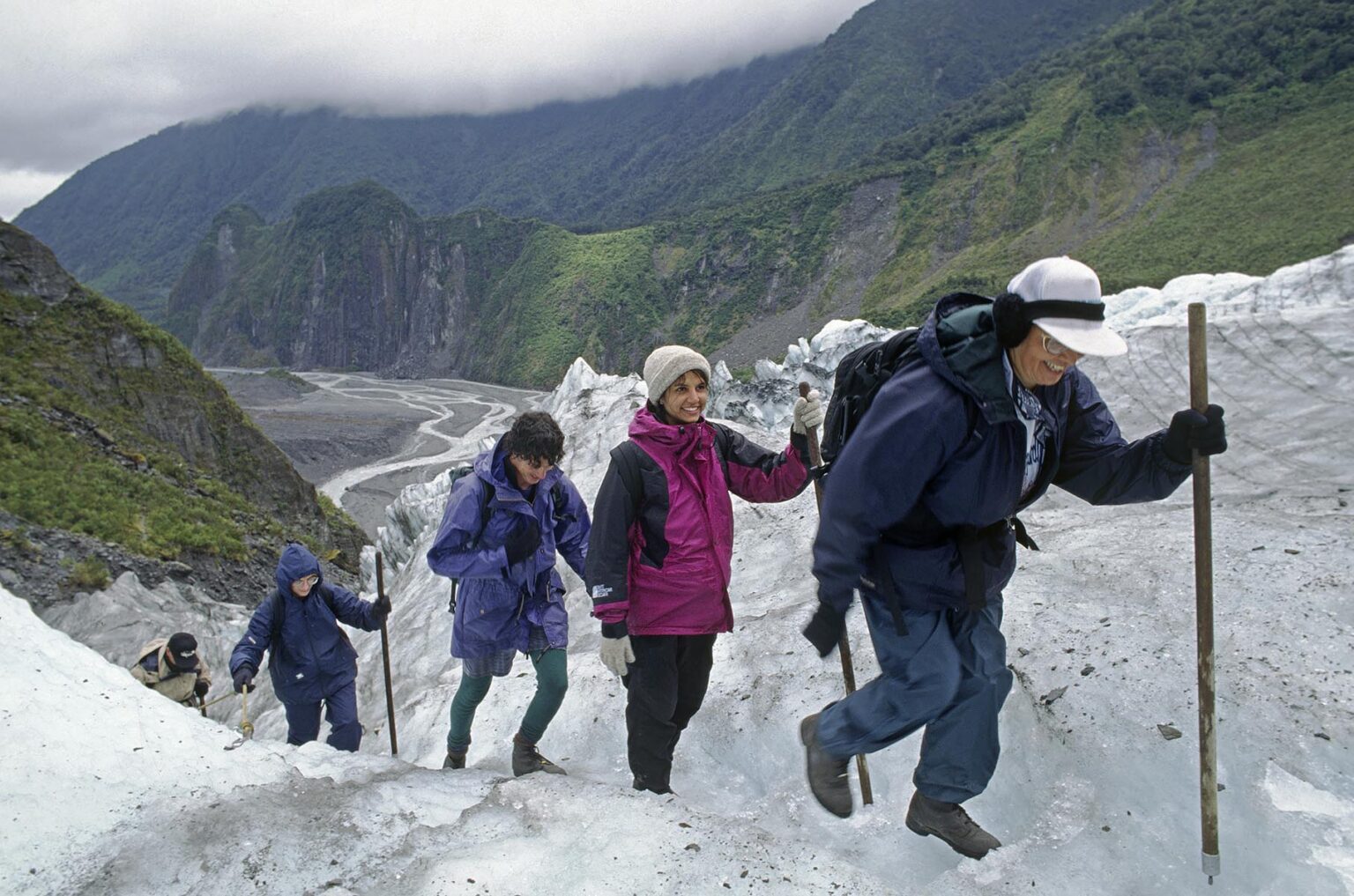 Climbing un carved ice steps on the FOX GLACIER, one of the worlds few advancing glaciers - SOUTH ISLAND NEW ZEALAND