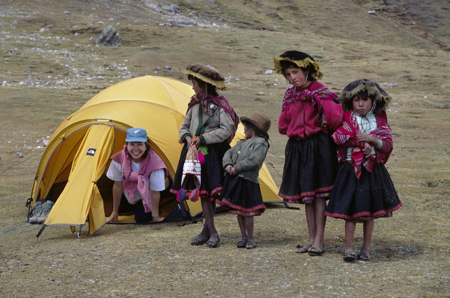Local QUECHUA girls visit a trekker in her tent - AUZANGATE TREK, PERUVIAN ANDES
