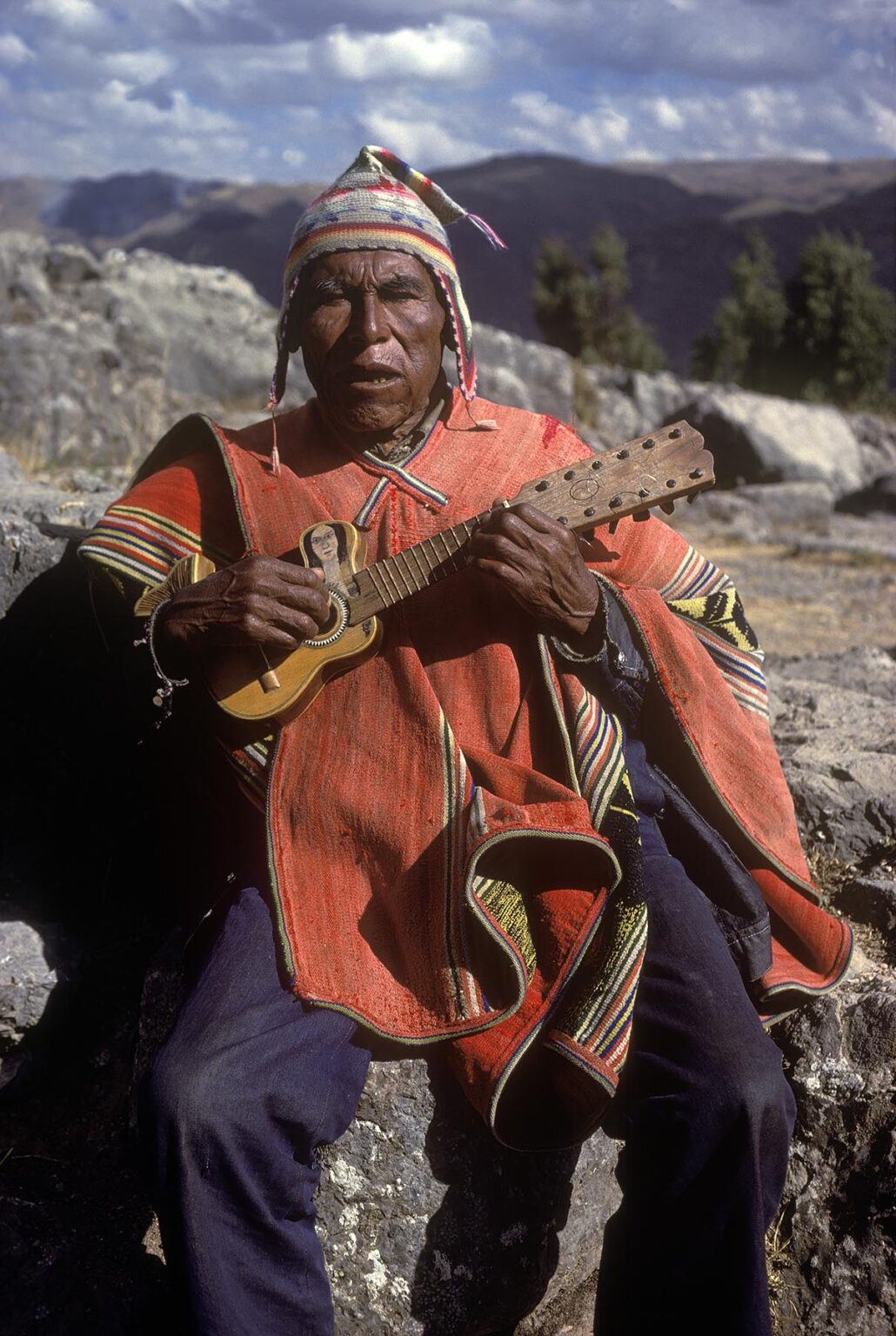 Old QUECHUA MAN playing guitar - PERUVIAN ANDES