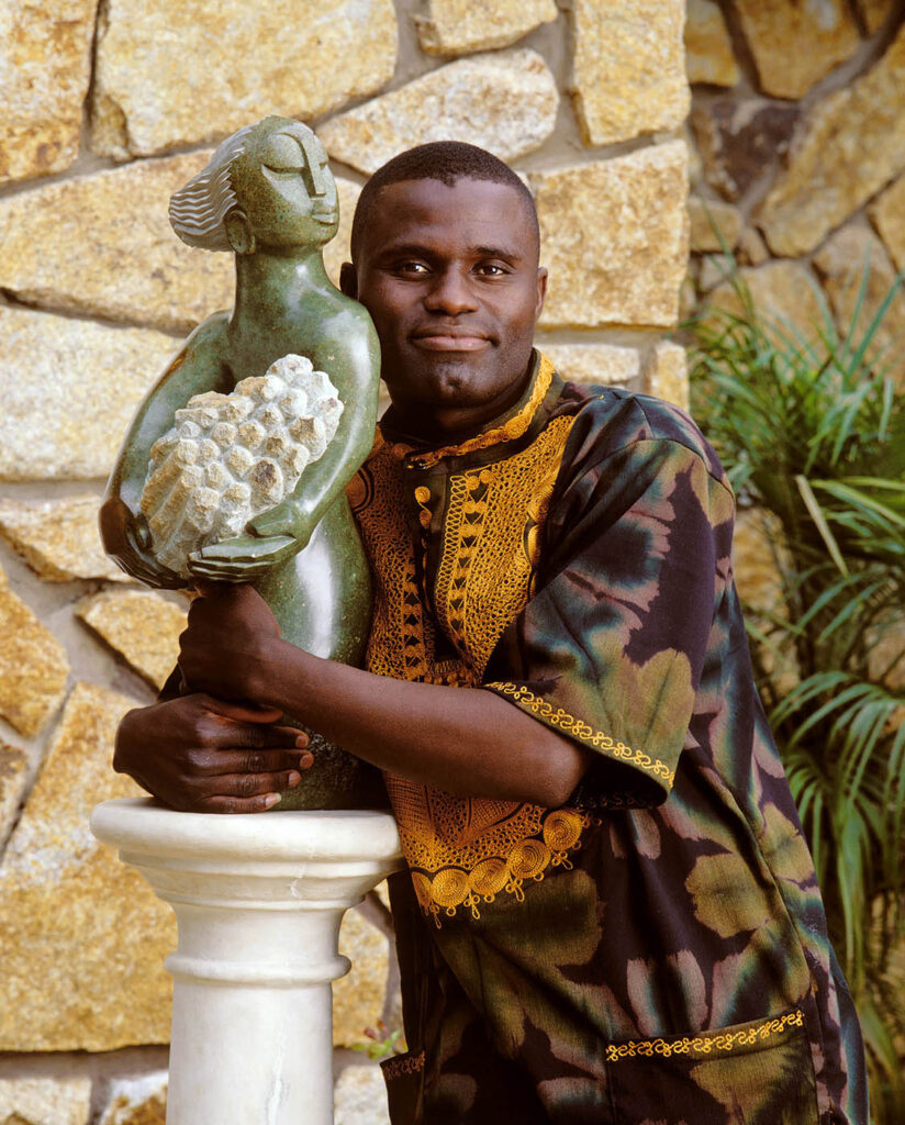 SCULPTURE titled PROUD OF MY RESPONSIBILITIES (Green Stone) by GEDION NYANHONGO - Shona people of Zimbabwe.  Portrait photograph by Craig Lovell.
