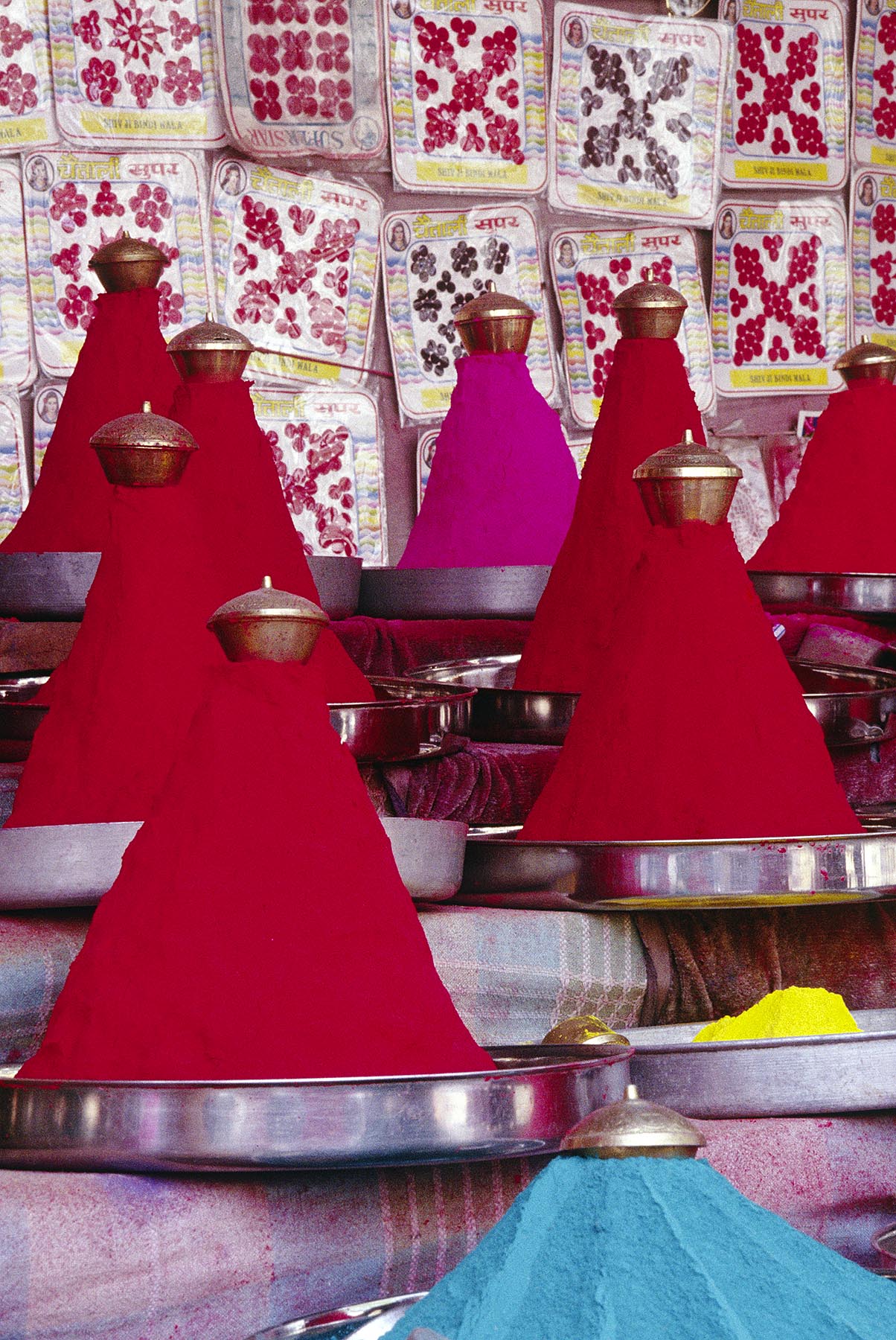 Piles of red TIKKA (BLESSING) POWDER in a market stall at the PUSHKAR CAMEL FAIR - RAJASTHAN, INDIA