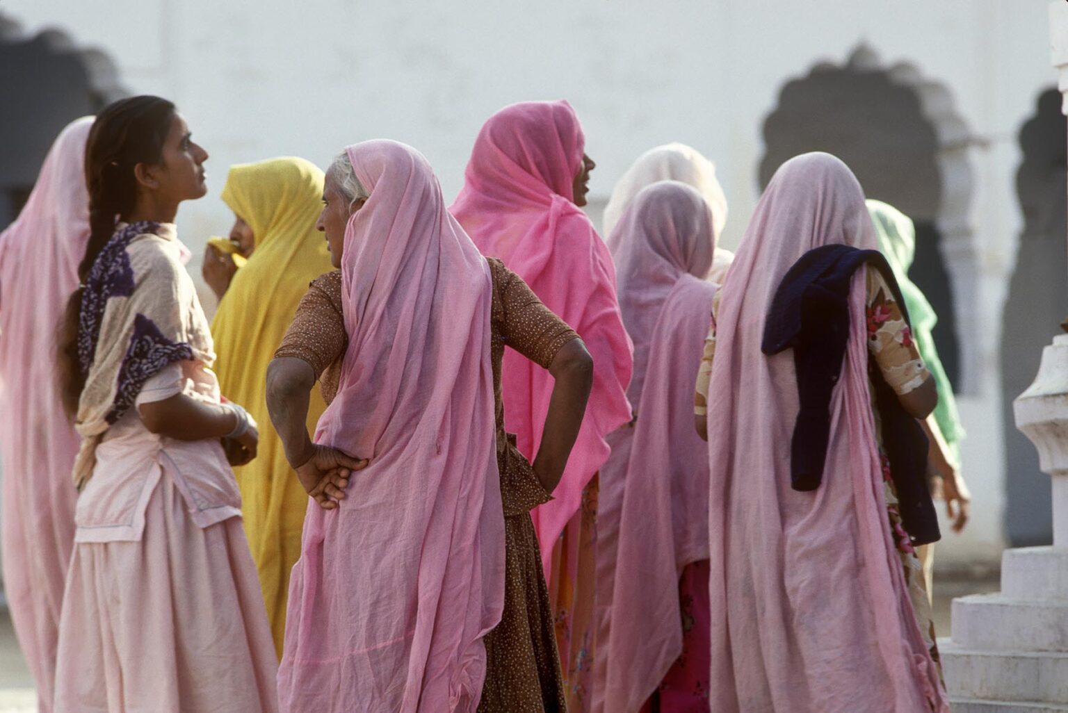 RAJASTHANI WOMEN in pink SARIS visit a TEMPLE at the PUSHKAR CAMEL FAIR - RAJASTHAN, INDIA