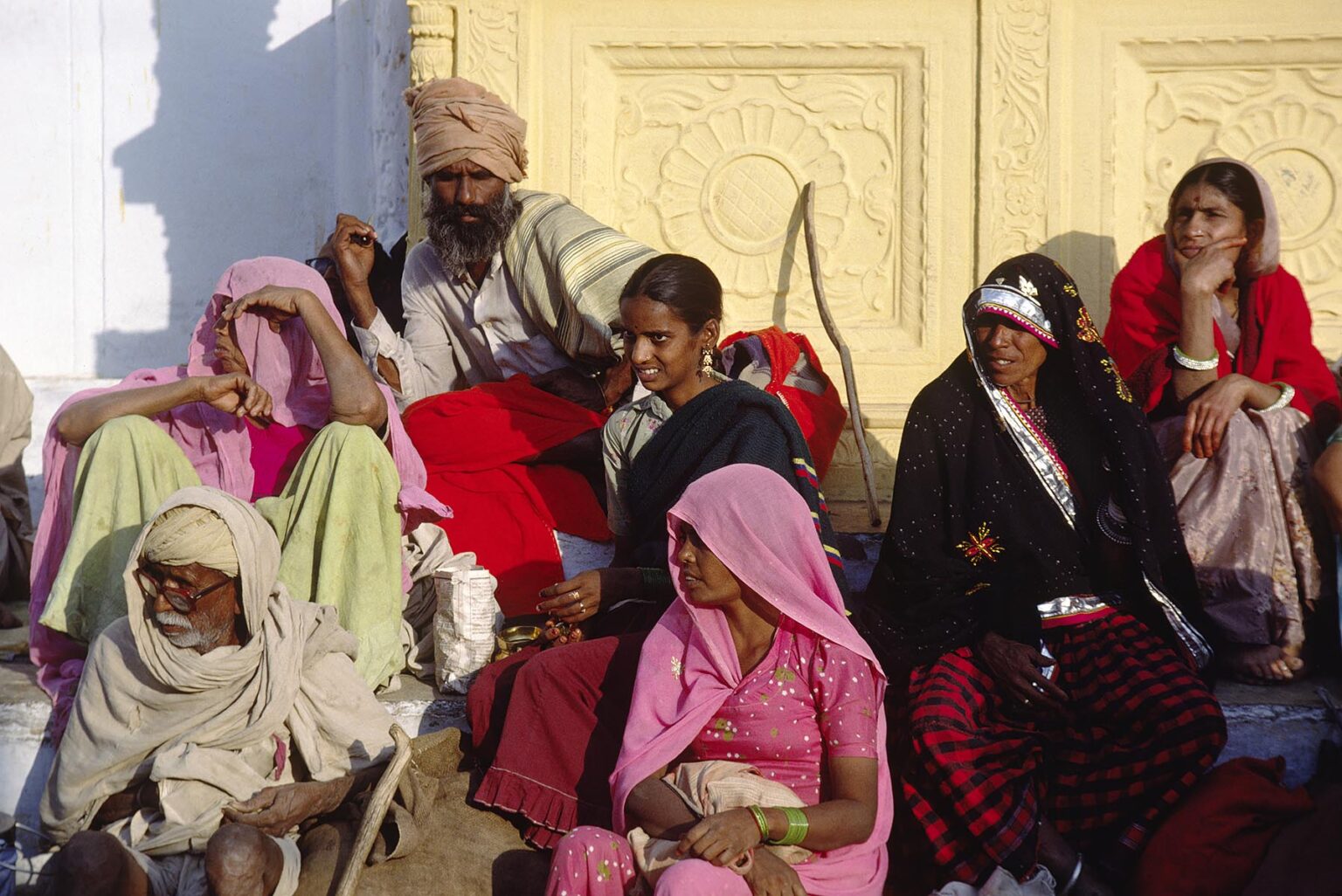PILGRIMS on the steps of OLD RANGJI TEMPLE at the PUSHKAR CAMEL FAIR, a 5 day religious festival - RAJASTHAN, INDIA