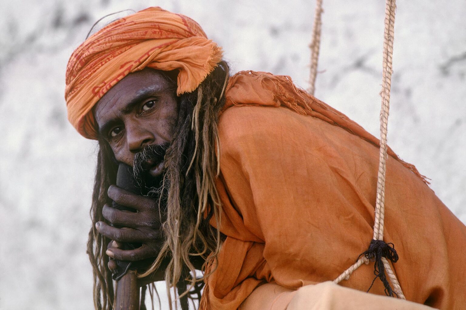 HINDU SADDHU in SWING with renunciate's vow to never lay on the ground at the PUSHKAR CAMEL FAIR - RAJASTHAN, INDIA