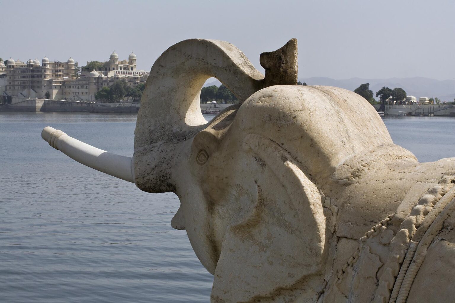 A STONE CARVED ELEPHANT guards the palace on JAGMANDIR ISLAND in LAKE PICHOLA which was built in 1620 AD by Maharaja Karan Singh - UDAIPUR, RAJASTHAN, INDIA