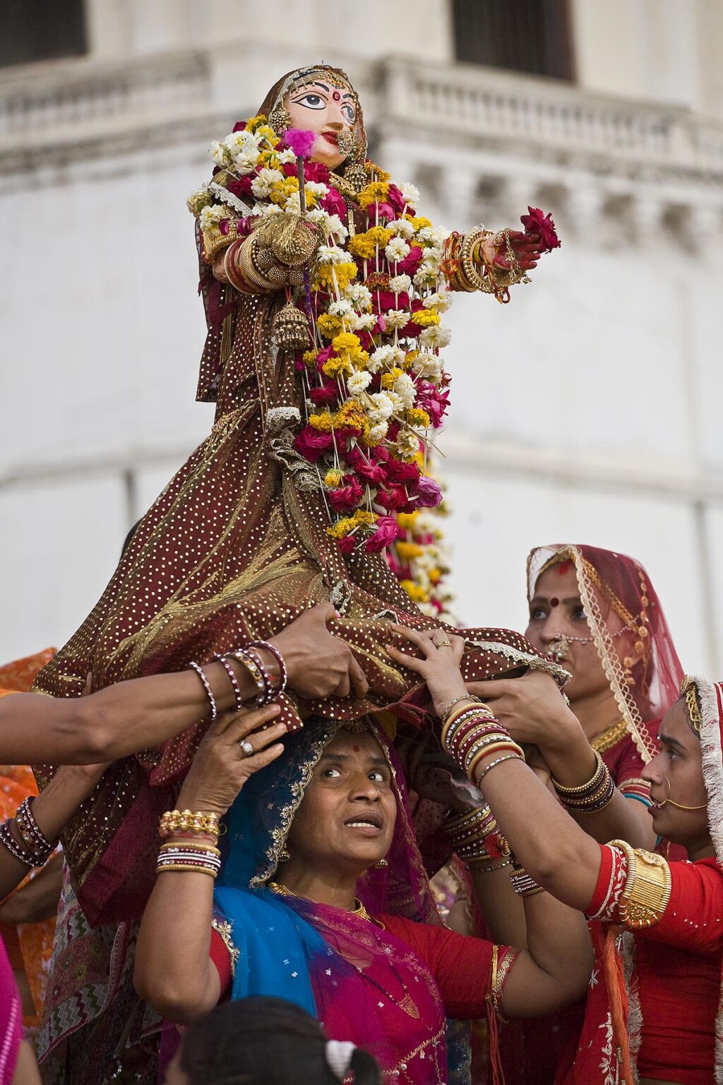 A Rajasthani woman carries an effigy of Shiva's wife Parvati at the GANGUR FESTIVAL also known as the MEWAR FESTIVAL in UDAIPUR - RAJASTHAN, INDIA