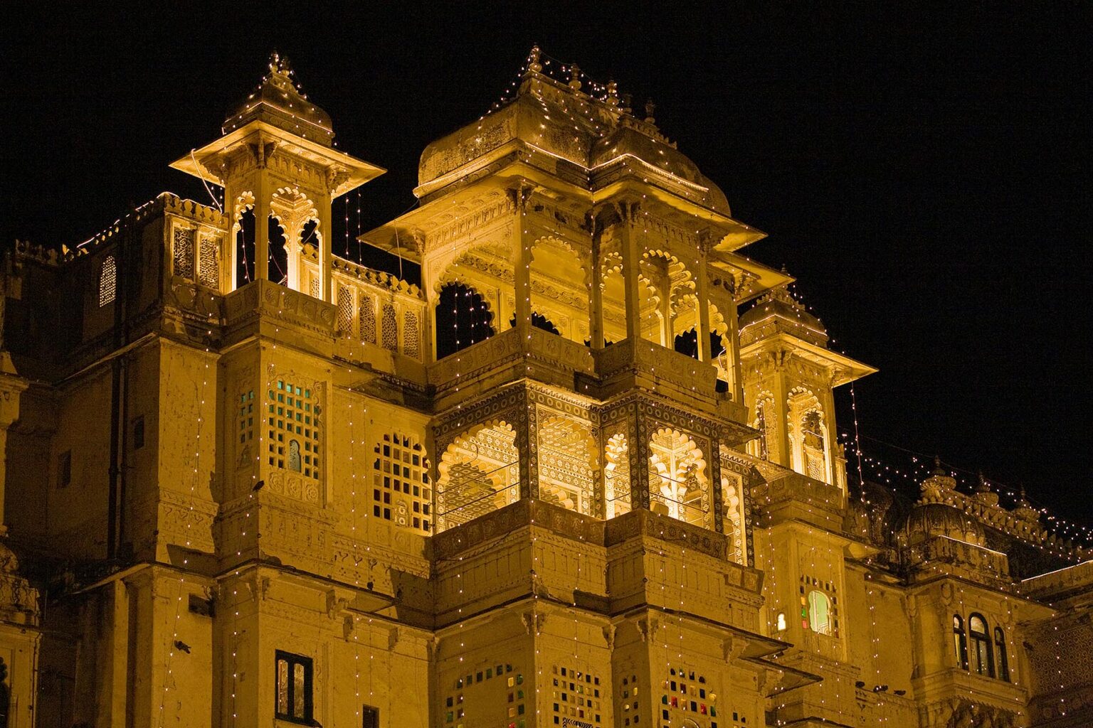 Night view of the CITY PALACE of UDAIPUR which was originally built by Maharaja Udai Singh ll in 1600 AD - RAJASTHAN, INDIA