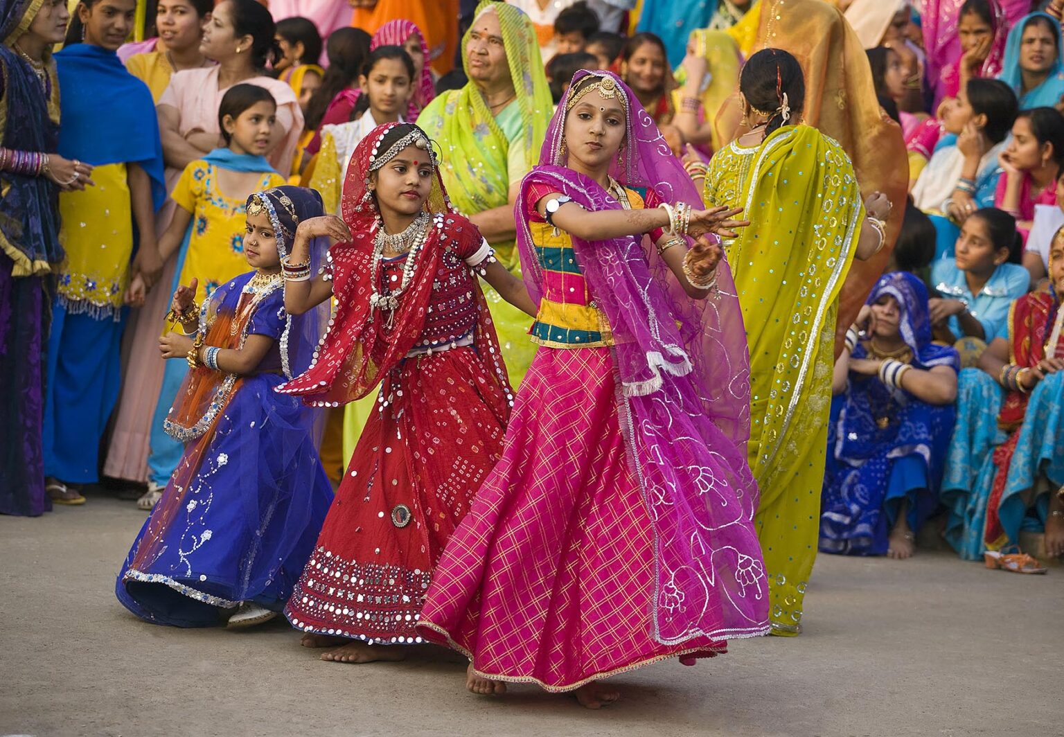Rajasthani girl dressed in their finest dances at the GANGUR FESTIVAL also known as the MEWAR FESTIVAL - UDAIPUR, RAJASTHAN, INDIA