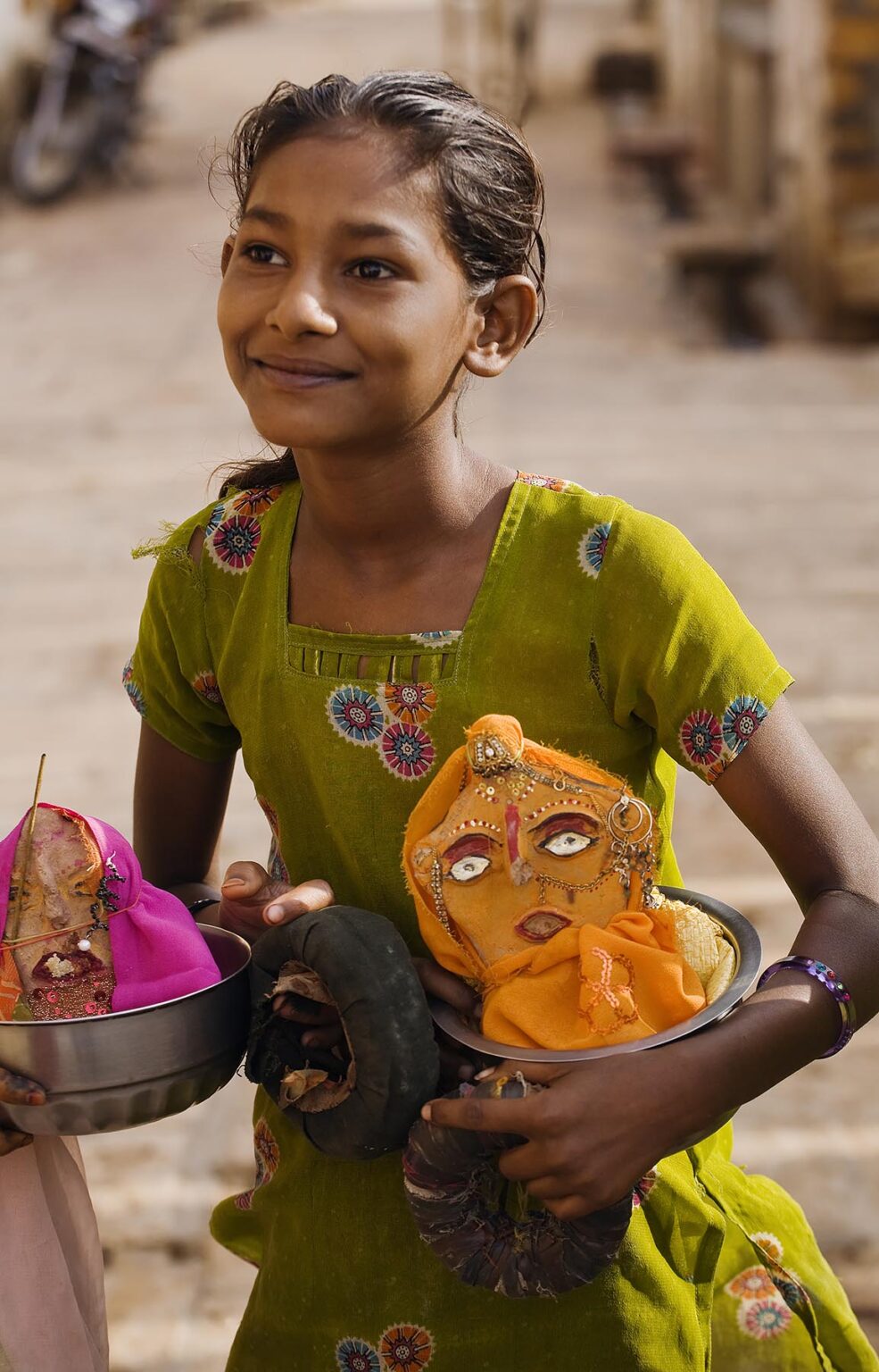 A young GIRL carries effigies of HINDU GODS during the GANGUR FESTIVAL in JAISALMER - RAJASTHAN, INDIA