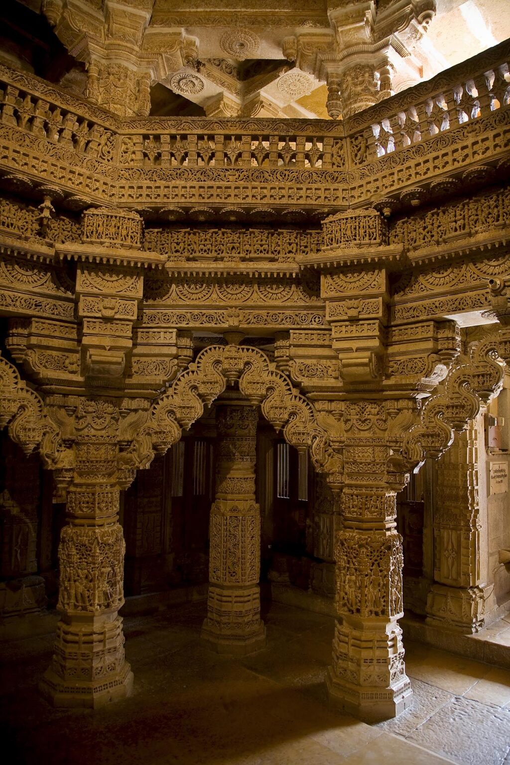 The hand carved sandstone PILLARS of the CHANDRAPRABHU JAIN TEMPLE inside JAISALMER FORT - RAJASTHAN, INDIA
