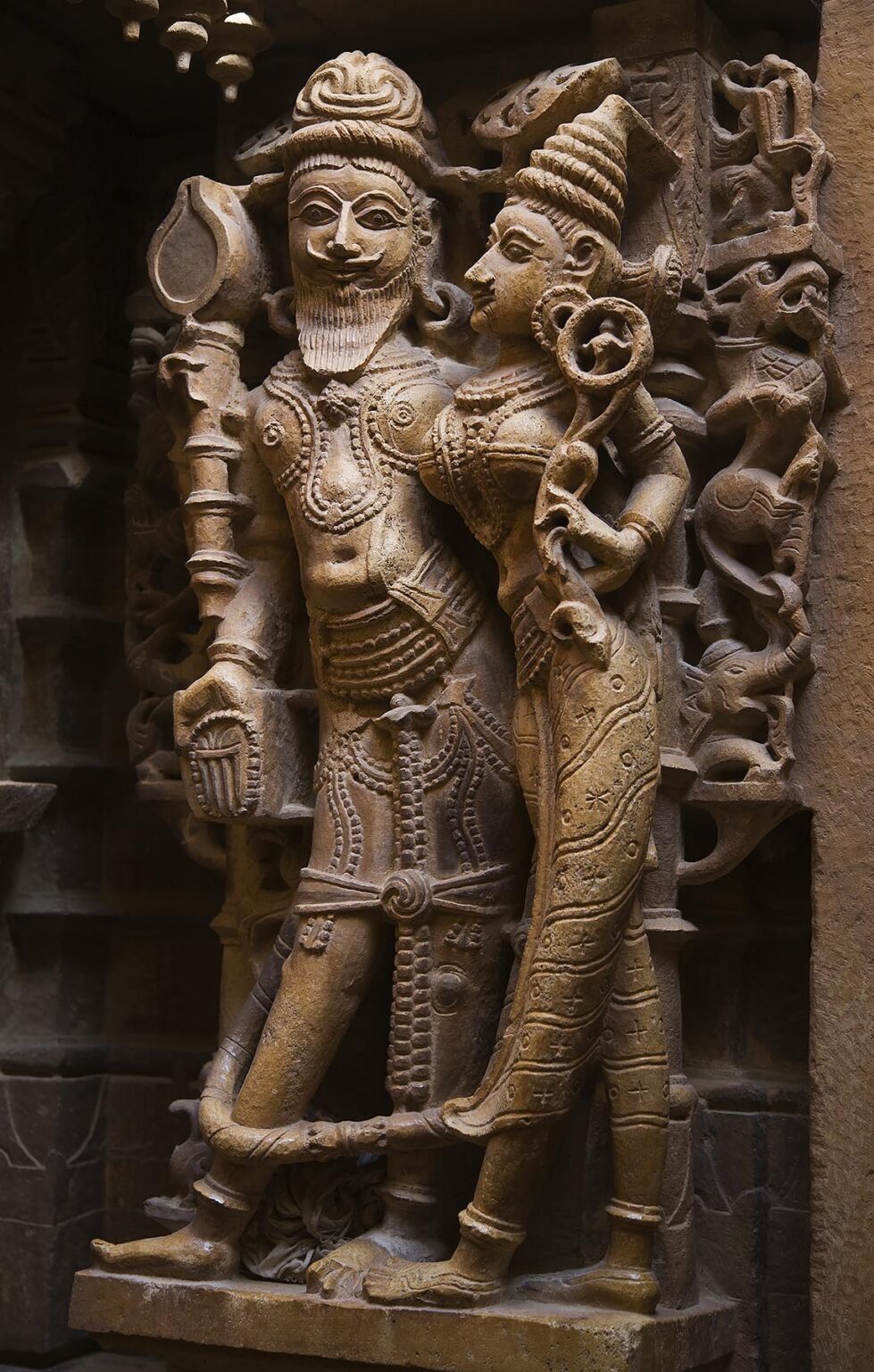 A hand carved SANDSTONE KING and his CONSORT in the  CHANDRAPRABHU JAIN TEMPLE inside JAISALMER FORT - RAJASTHAN, INDIA