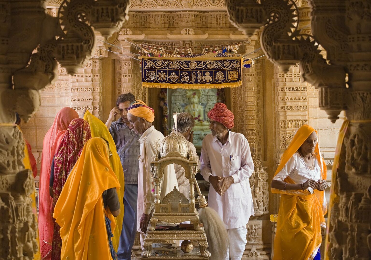 Indian pilgrims inside a JAIN TEMPLE in the JAISALMER FORT - RAJASTHAN, INDIA